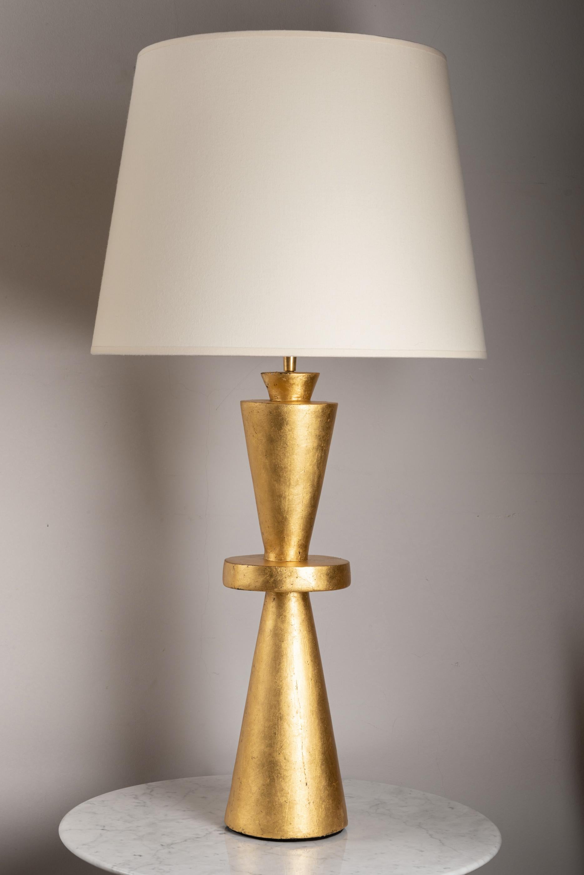 Pair of plaster lamps. 
Hand gilded with 22 carat gold leave 
With custom made shades.
France, contemporary creation
Wired for Europe.

Measures: 
Total height : 86.5cm - 34 inches
Plaster base height : 52.5 cm - 20.7 inches
Diameter