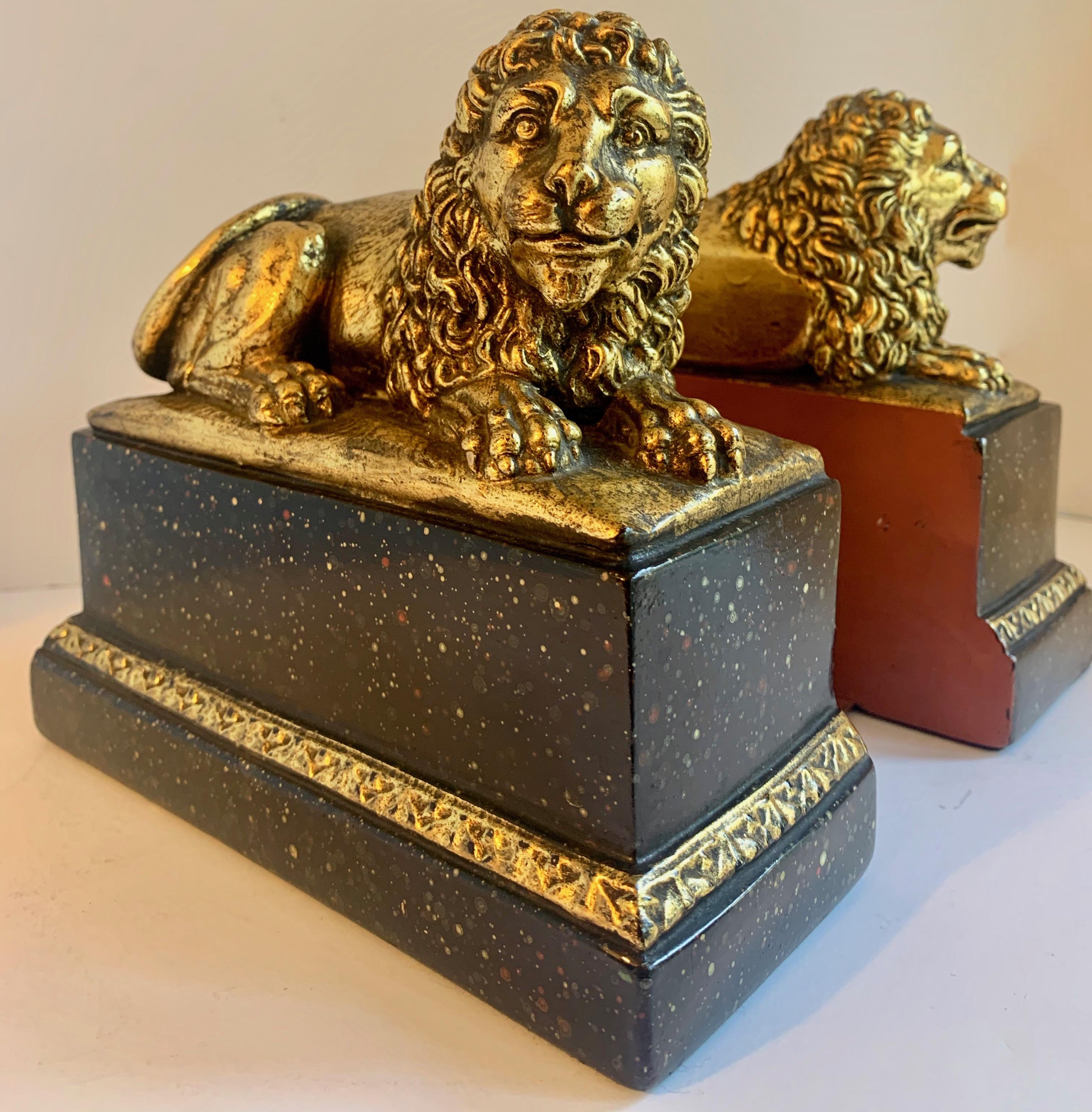 Stunning pair of gilt lions on a black base - most likely Borghese with the traditional red back with the flat support for books - very decorative and eye catching - a perfect compliment to many desks / libraries. A wonderful pair.