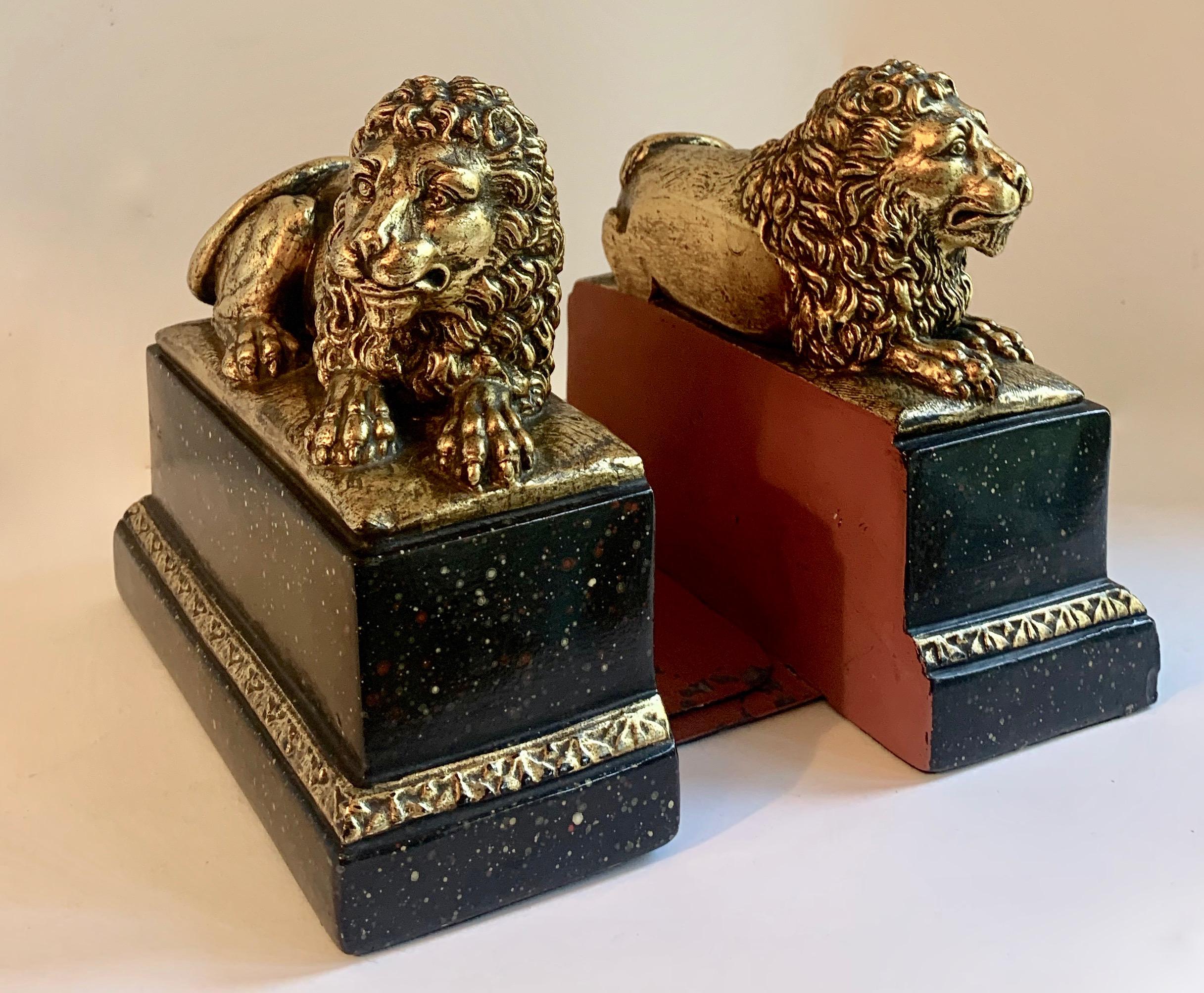 French Pair of Gilt Reclining Lions on Black Stands