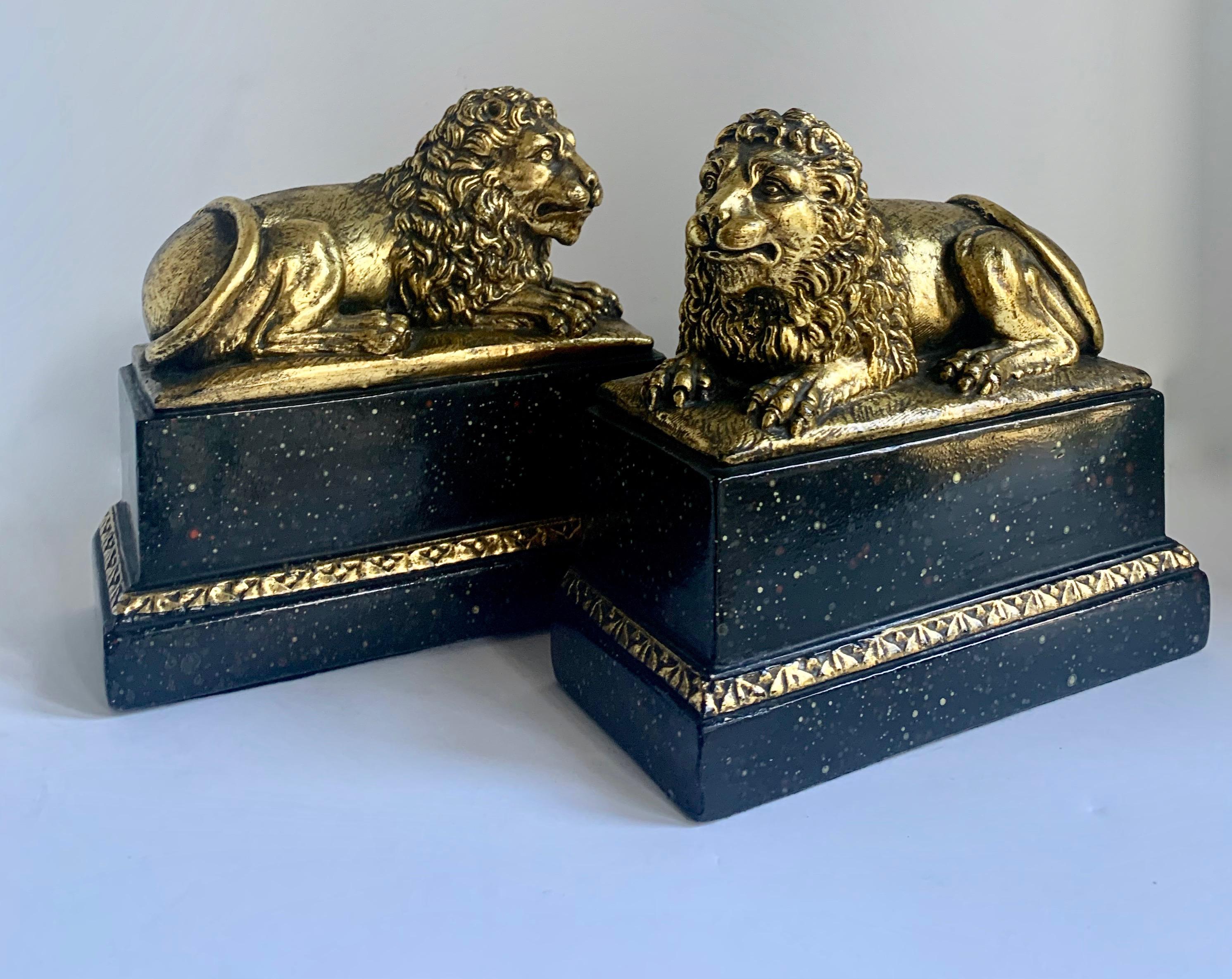 Pair of Gilt Reclining Lions on Black Stands 1