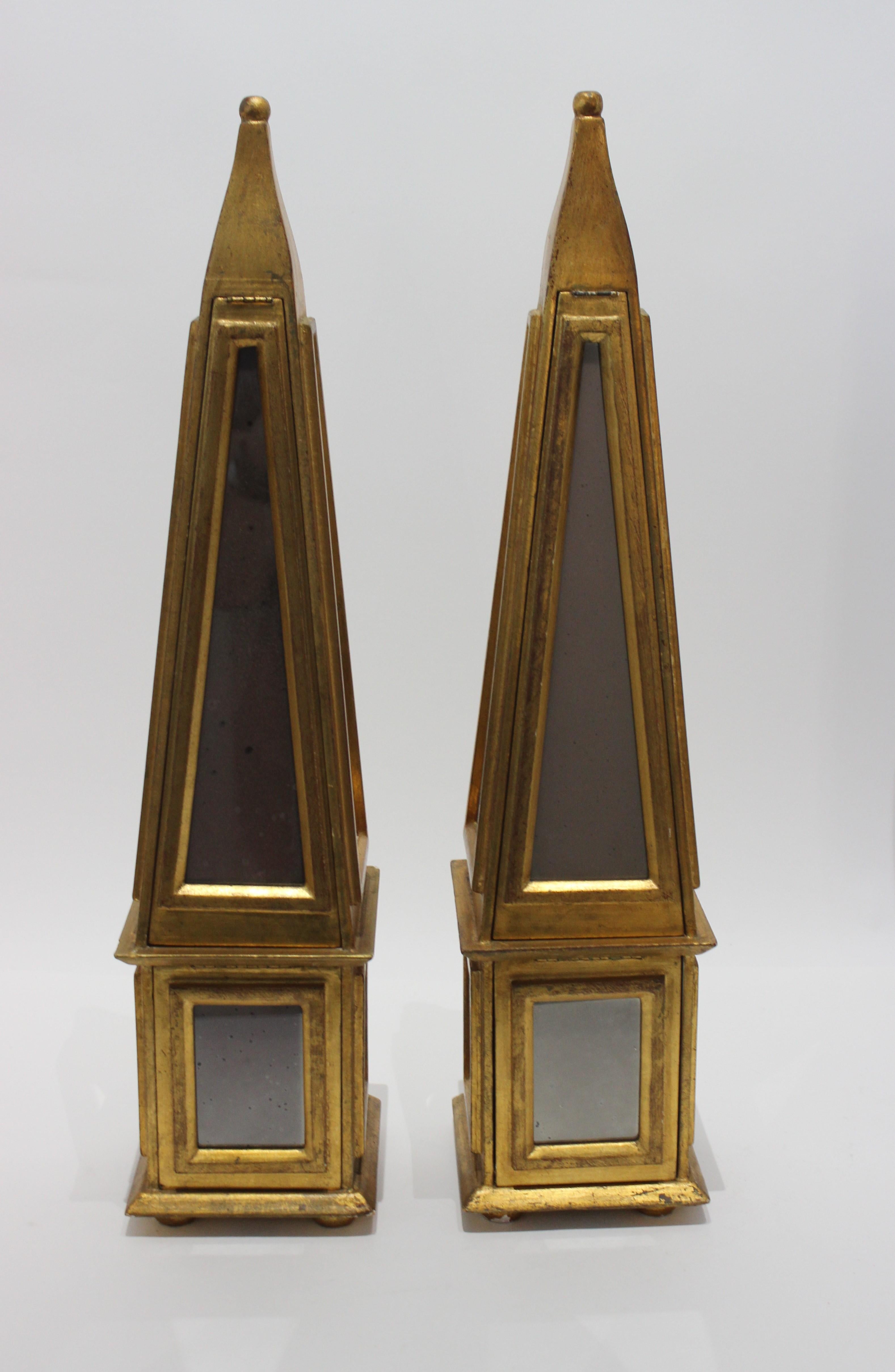A fabulous pair of 1960s Italian Florentine obelisks, mirror and giltwood.
We discovered each one as a secret compartment -- see pictures. A secret nook in each for hiding things.
