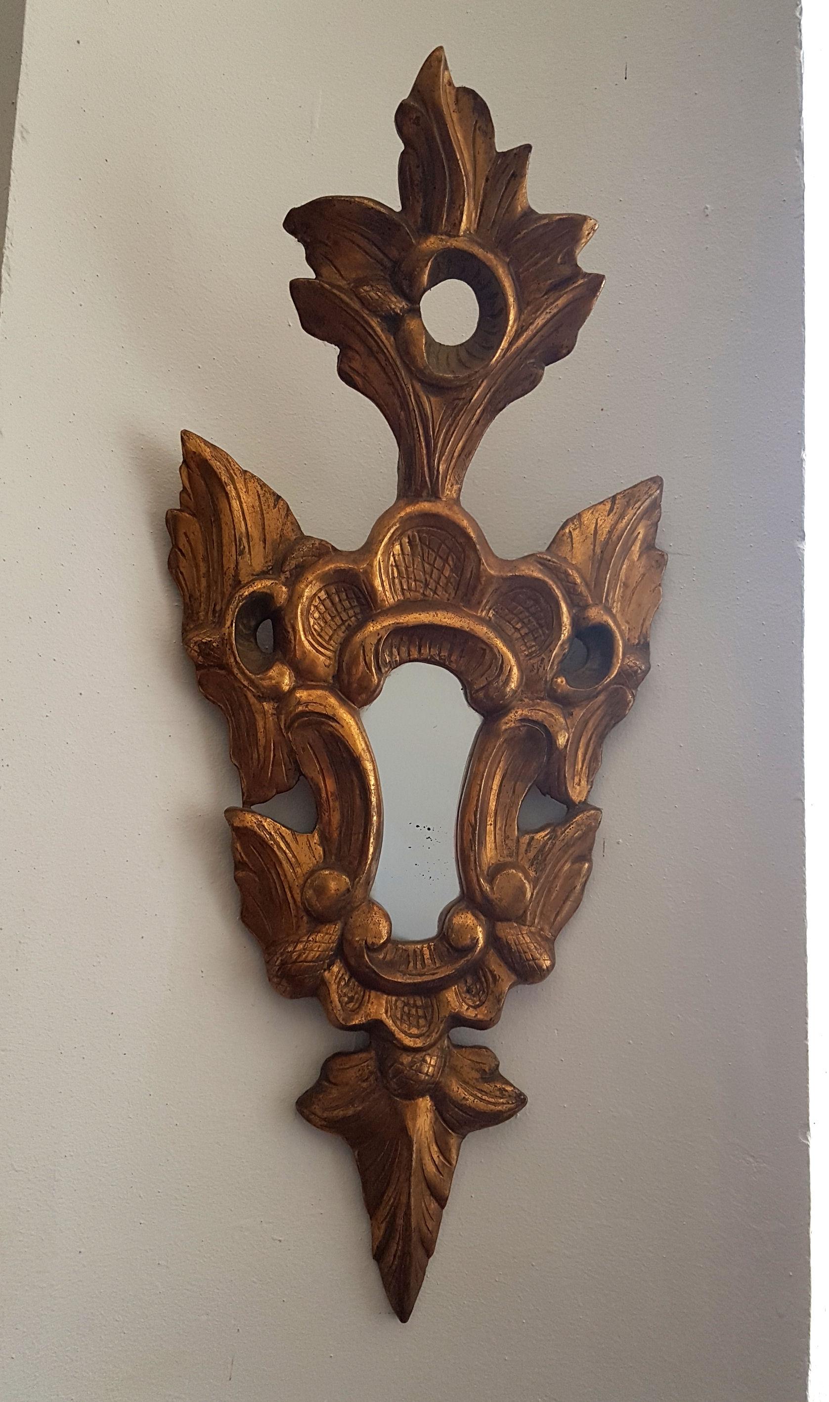 Pair of small giltwood, sculpted wall mirrors. With a Louis XV giltwood decoration, in a neoclassical, or Renaissance style.
Original mirror at the center,  
France, circa 1920s or older.
Very good condition.