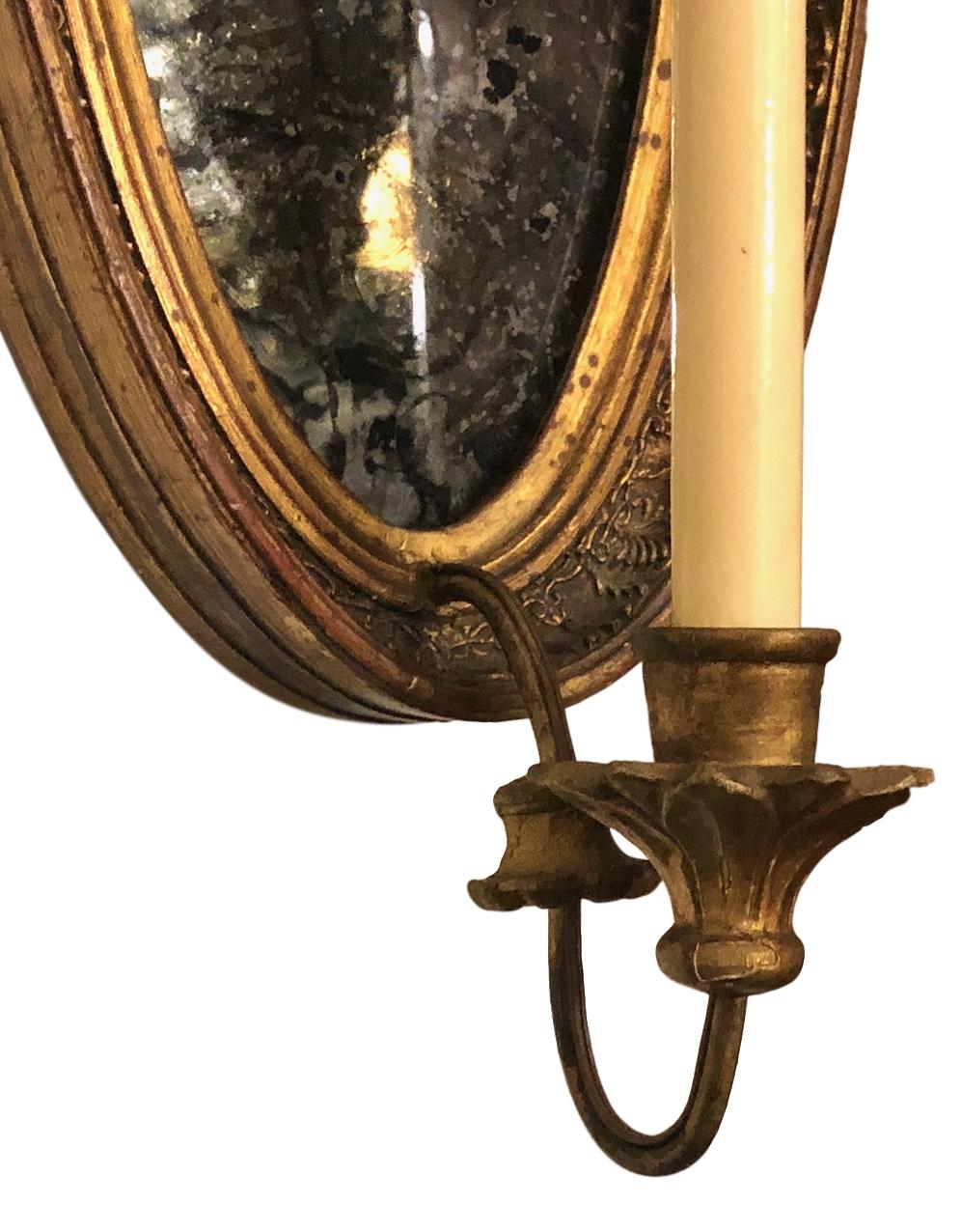 Pair of 1920s French carved and giltwood sconces with mirror backs.

Measurements:
Height 25.5?
Depth 9.5?
Width 9.5?.