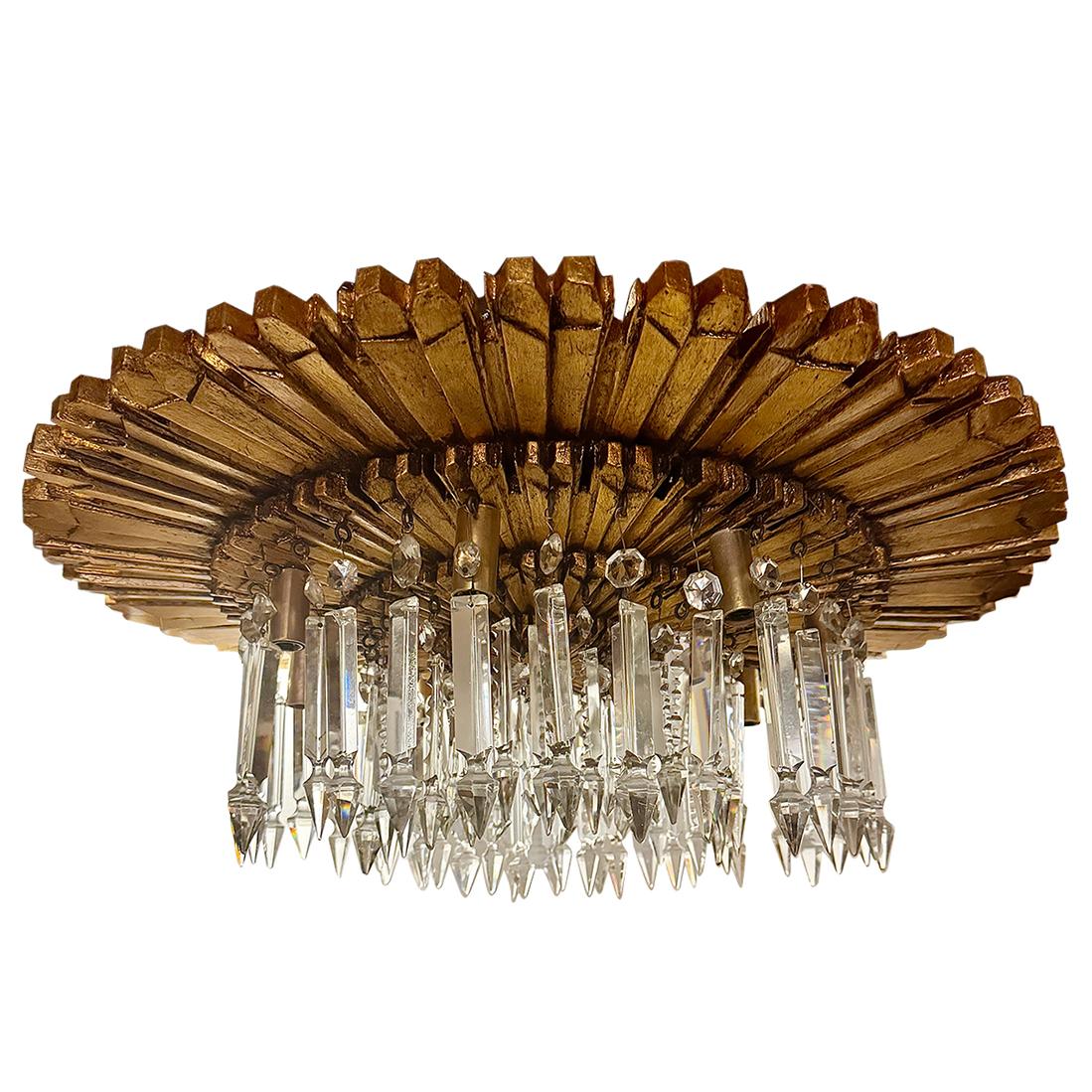 A pair of 1940's Italian carved wood sunburst shaped light fixture with crystal drops, original gilt finish, patina and eight lights. Sold individually.

Measurements:
Height: 9.5