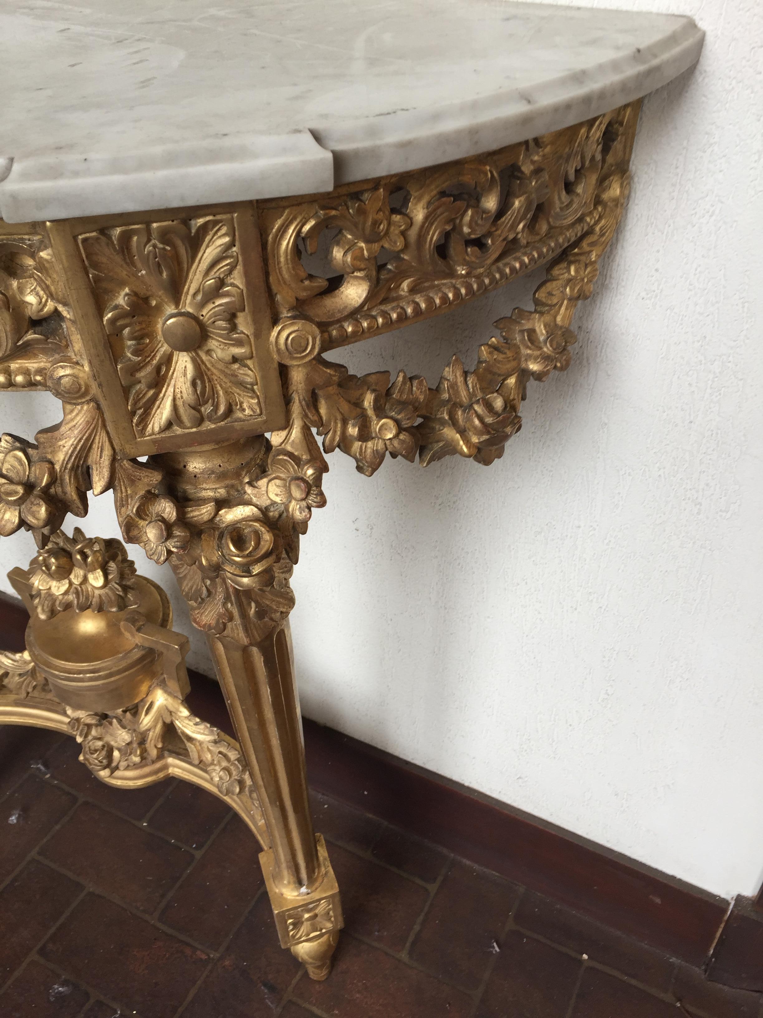 Pair of console louis XVI giltwood console with marble top 
they have an openwork belt ,the spacer with garland are finely carved .The execution and the carved of this pair of console are high quality 
these console are all wood.