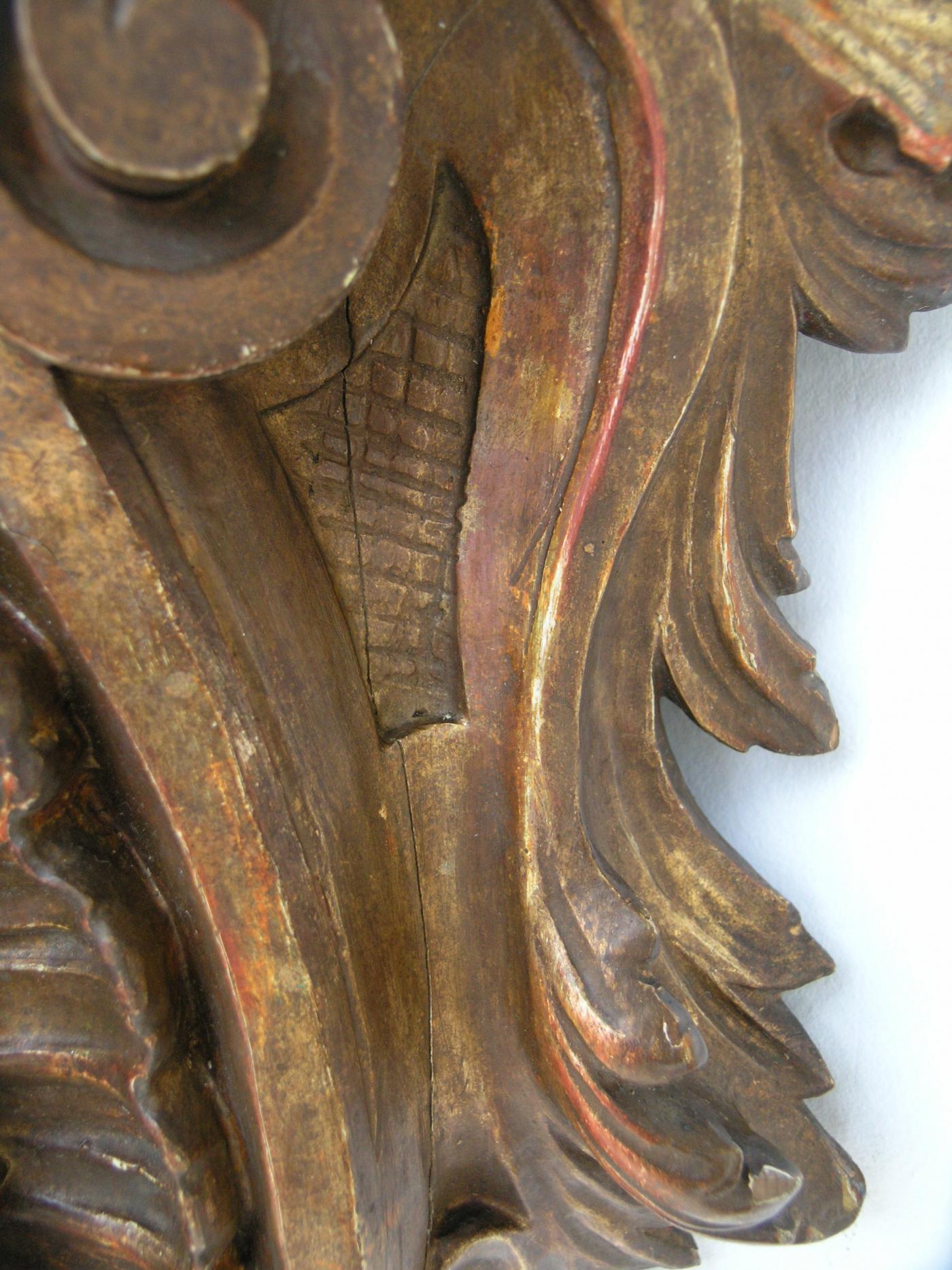 Shaped plateau and stiff leaf frieze on a C- scroll and flowerhead shaped support