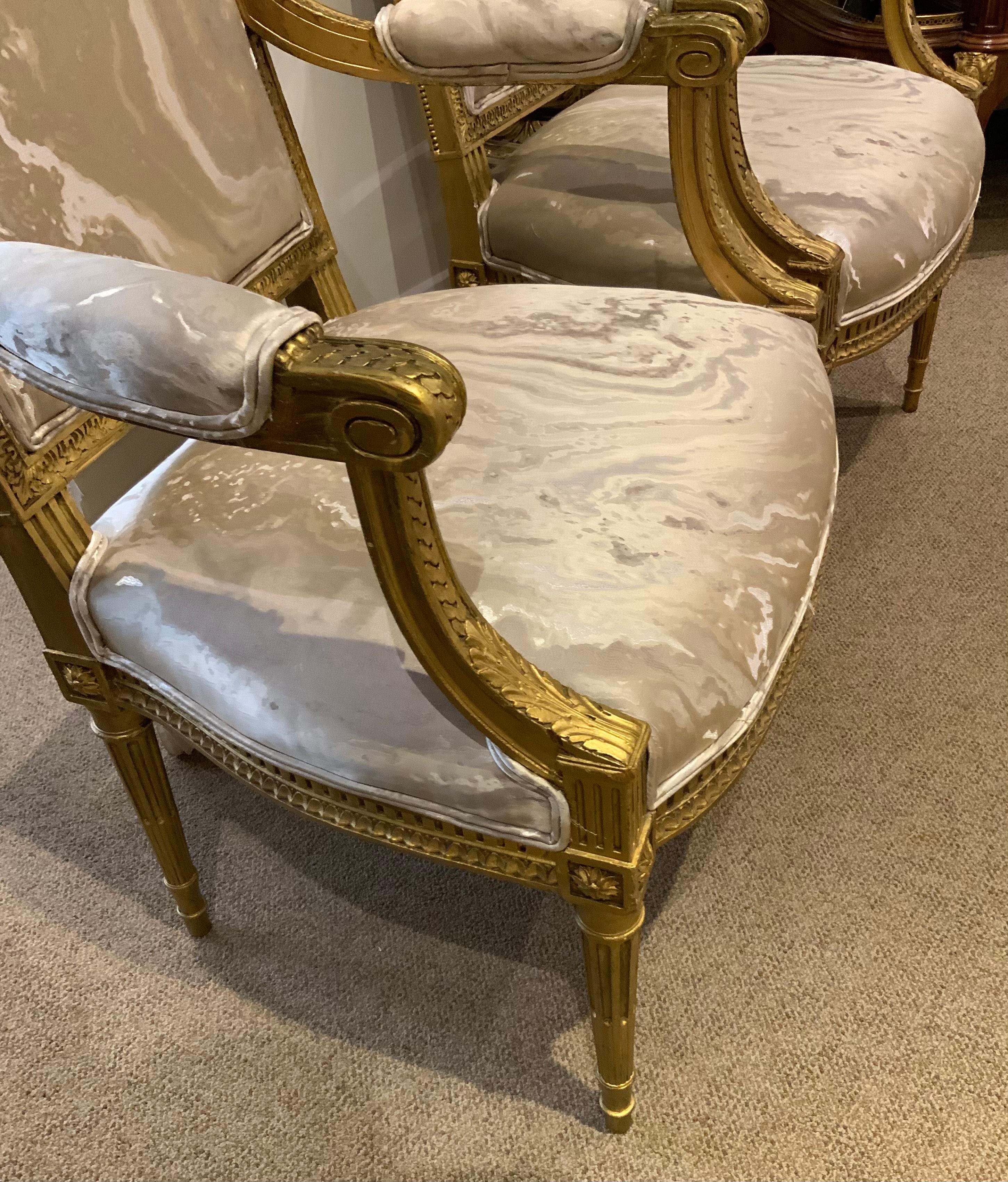 Fine giltwood hand carving makes these chairs exceptionally fine.
The gilding is original with a soft patina. The legs are reeded and
A circular pendant design is set on the corners. The squared 
Back is a sophisticated design that works well with