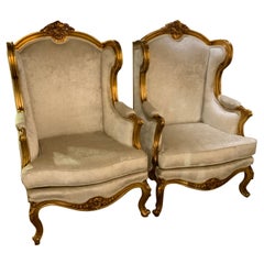 Coppia di sedie Wingback/Bergere francesi in legno dorato in stile Luigi XV