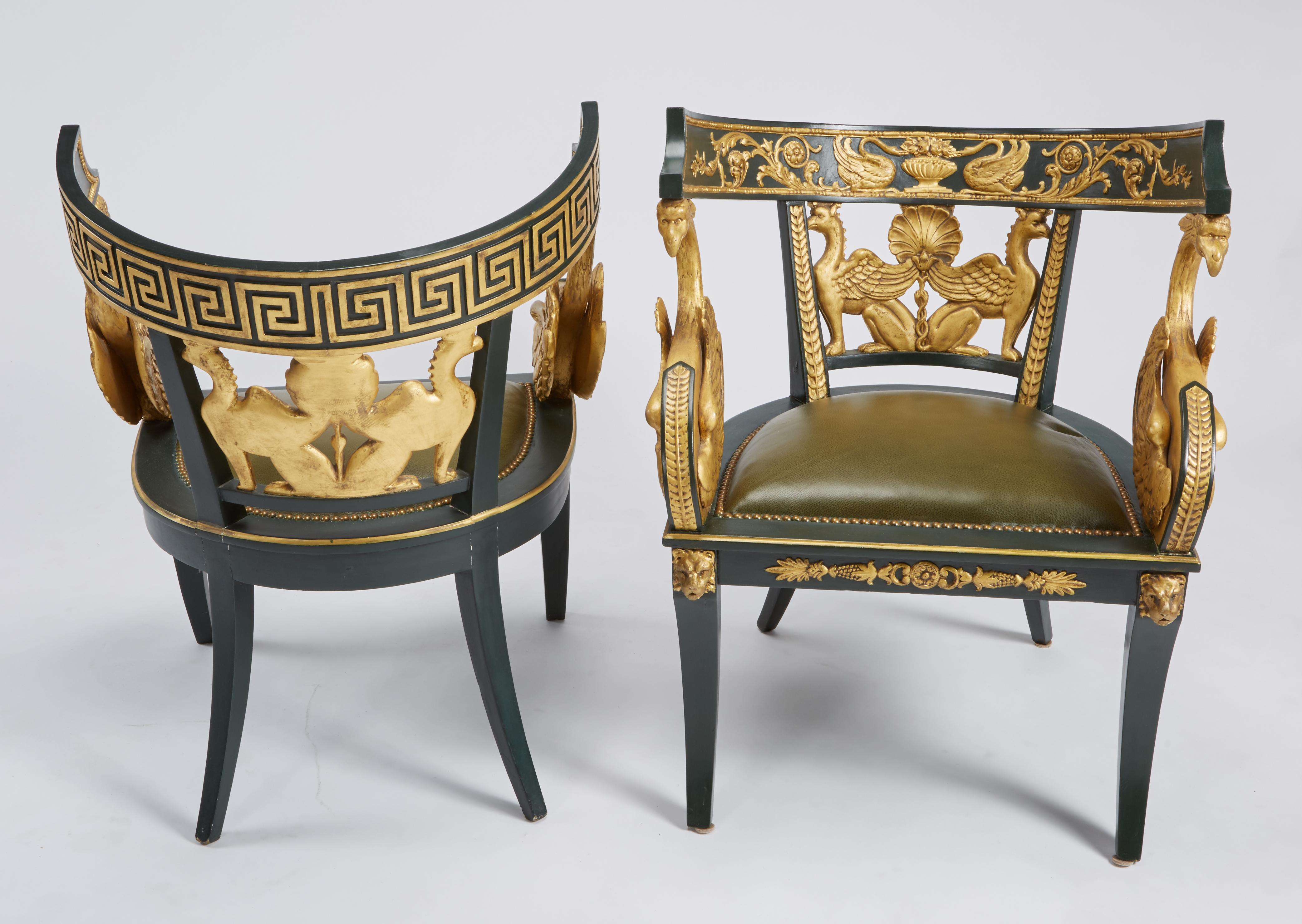 Impressive pair of Imperial Roman Style lounge chairs, having large carved giltwood swans, griffins, lion heads, shell, foliate and Greek key backs with newer Holly Hunt green leather upholstery and brass tacks on sabre legs. Italian, circa 1920s