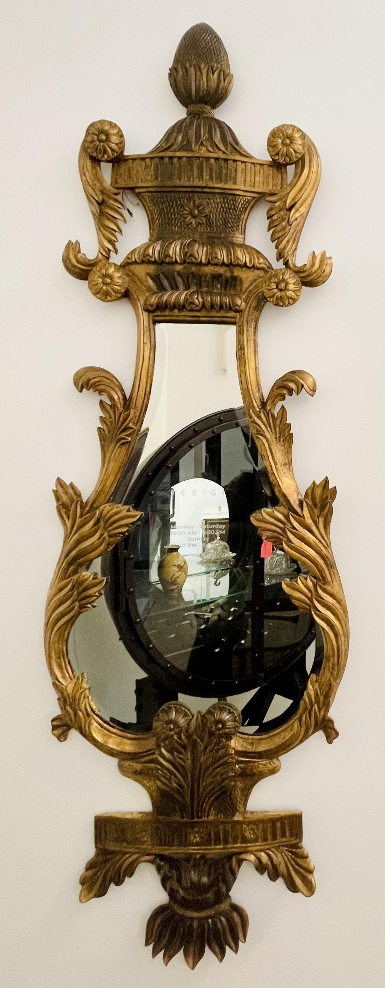 A fine pair of Italian giltwood wall or console mirrors.
 
The pair having a harp shape with pinapple carved pedimont and all around giltwood carvings with a clean beveled mirror center. 
 
IXgZ.