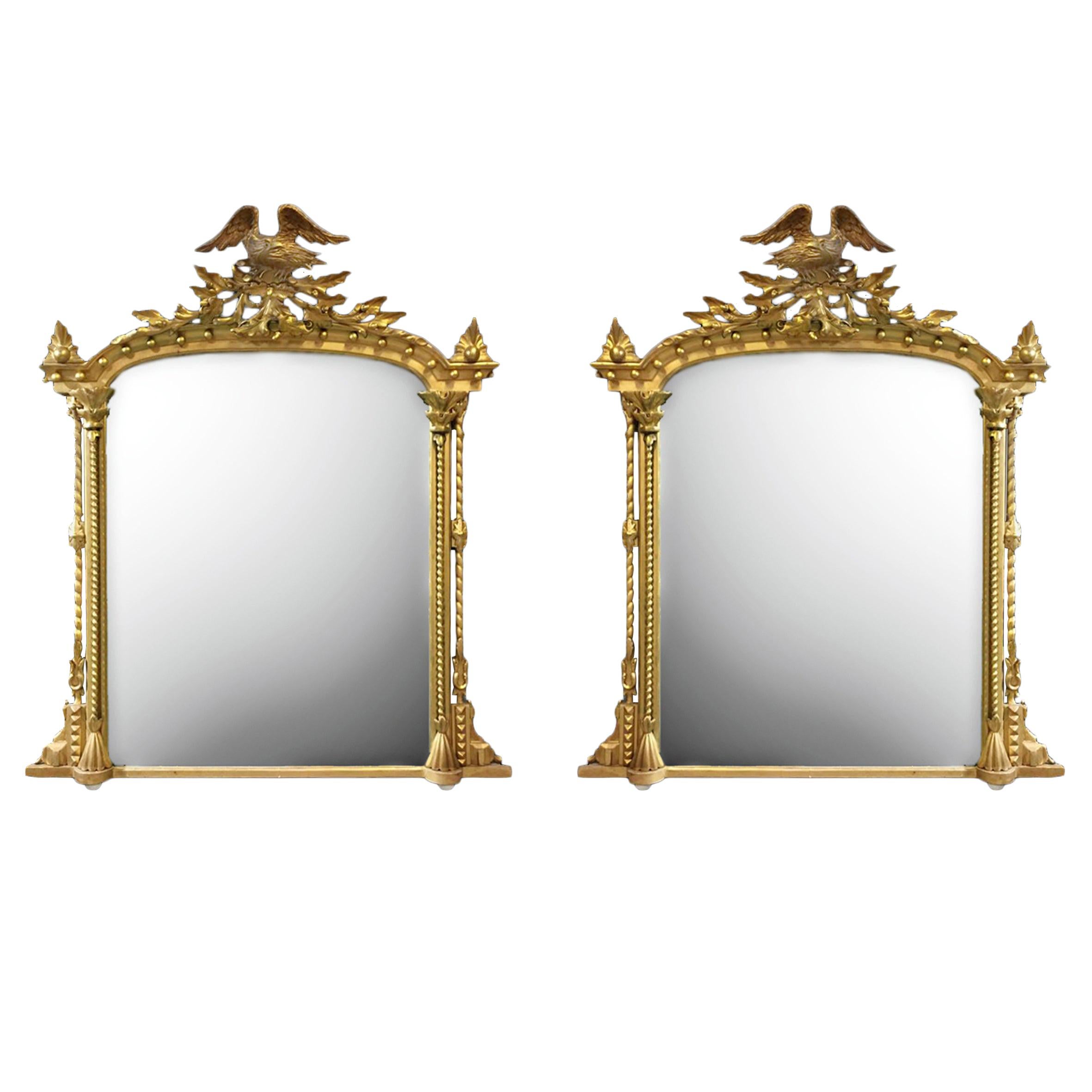 Paire de miroirs en bois doré avec crémaillères en forme d'aigle