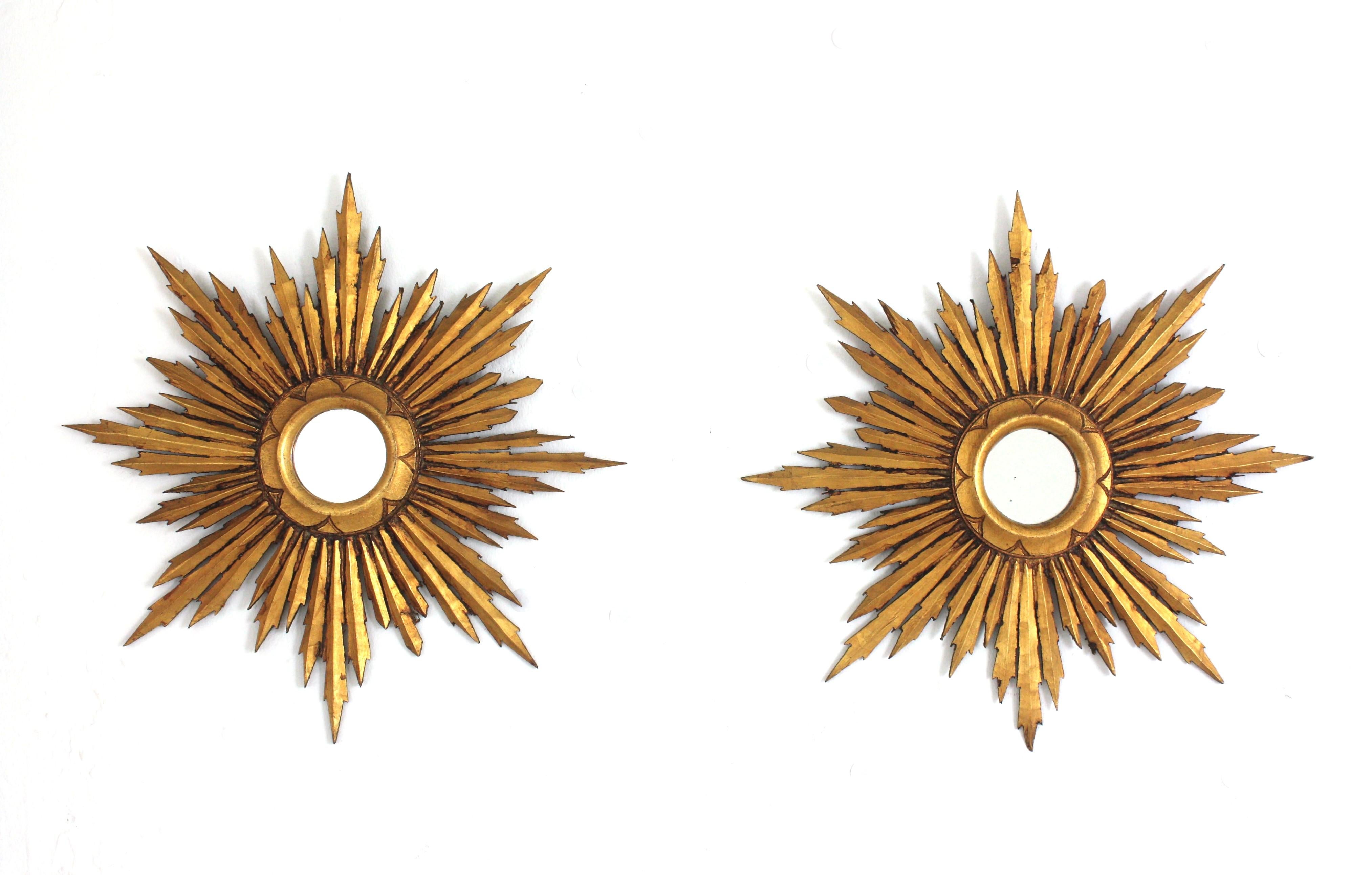 Paire de miroirs en bois doré de style baroque espagnol en forme d'étoile ou de soleil, années 1940-1950
Miroirs en bois doré de petite taille, de style baroque, avec une finition à la feuille d'or. 
Ces magnifiques miroirs en forme de soleil