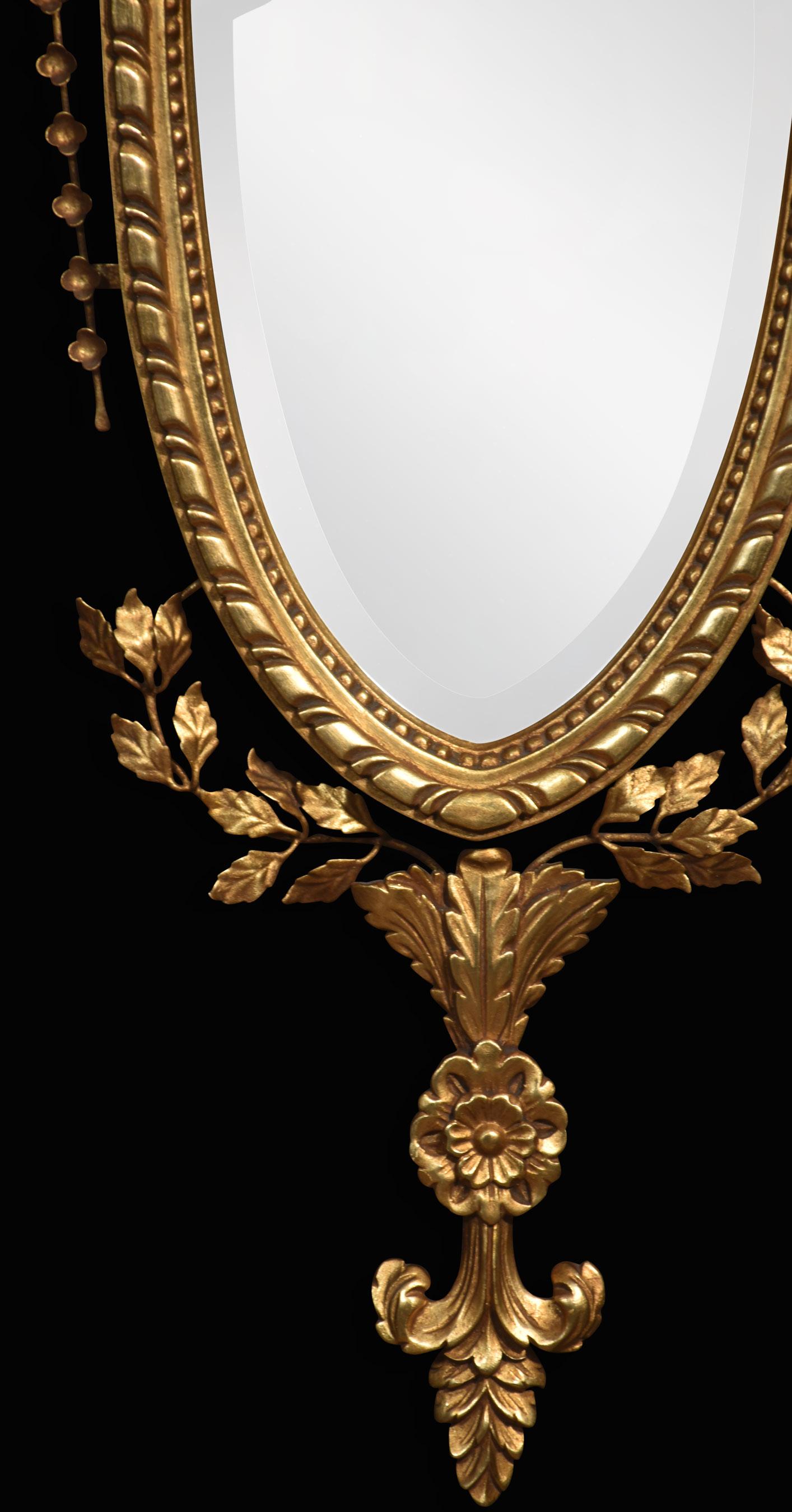 Pair of gilt-wood wall mirrors, the feather cresting above harebell swags to the central original bevelled mirror having a smaller oval mirror above, encased in a carved giltwood frame with leaf decoration.
Dimensions
Height 47.5 Inches
Width 17