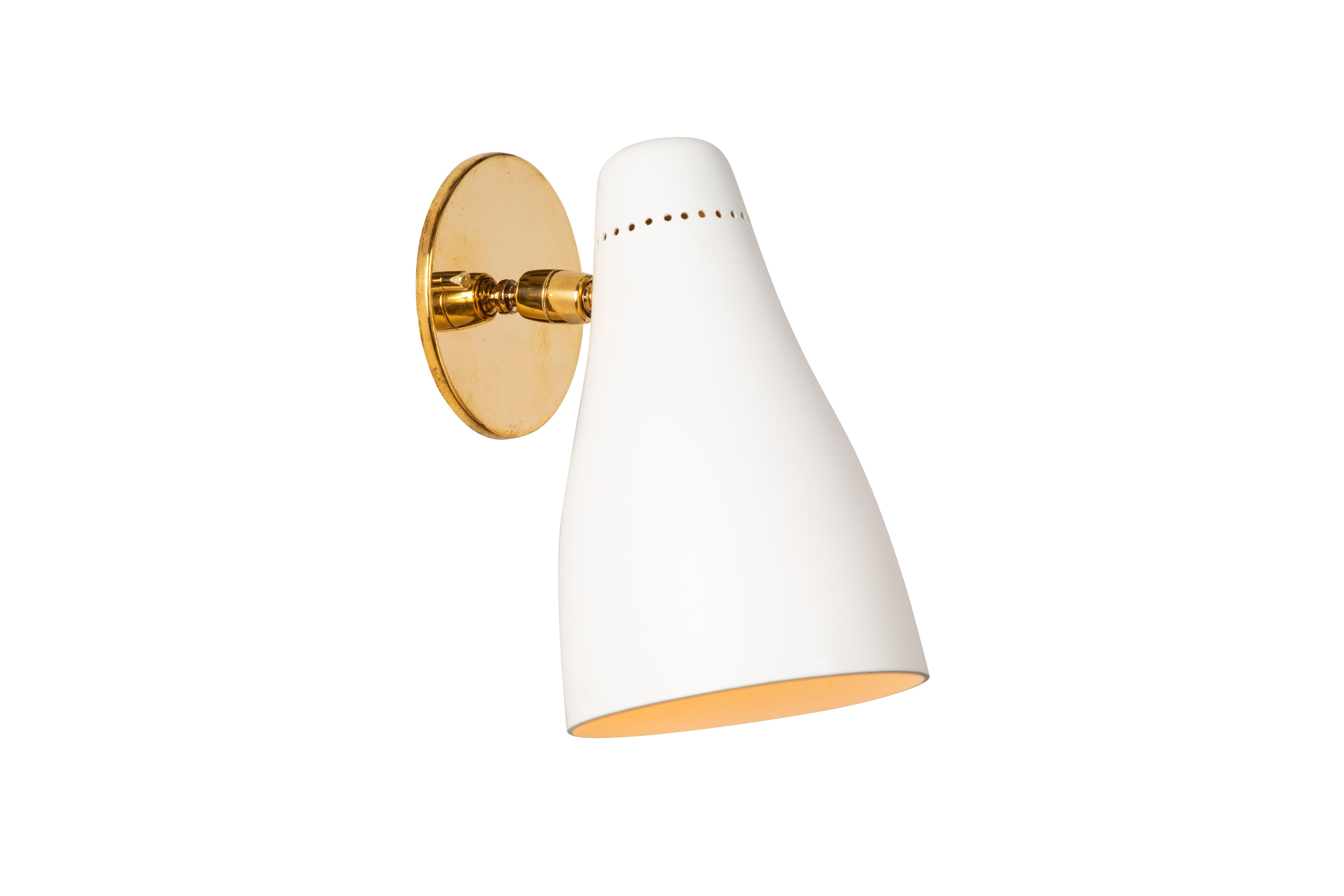 Pair of Gino Sarfatti perforated cone sconces for Arteluce, circa 1950. Executed in white painted perforated aluminum and brass. Ball jointed arm connection to shade allows for flexible shade adjustments and multiple configurations. The simplicity