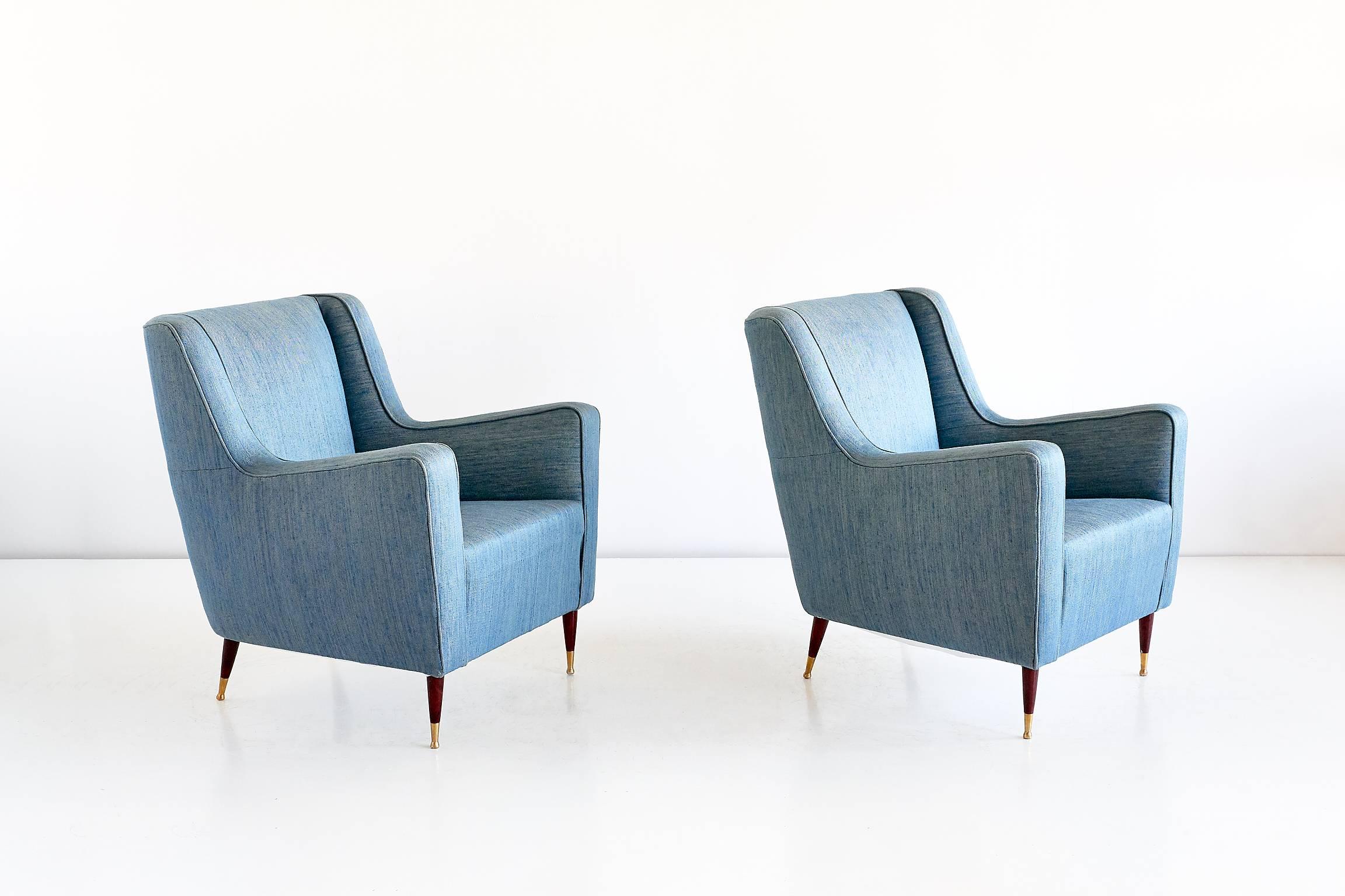 This rare pair of armchairs was designed by Gio Ponti in the late 1940s. The comfortable lounge chairs are characterized by their modern lines, elegantly tapered legs and brass feet. The model of this chair was designed for the Conte Grande