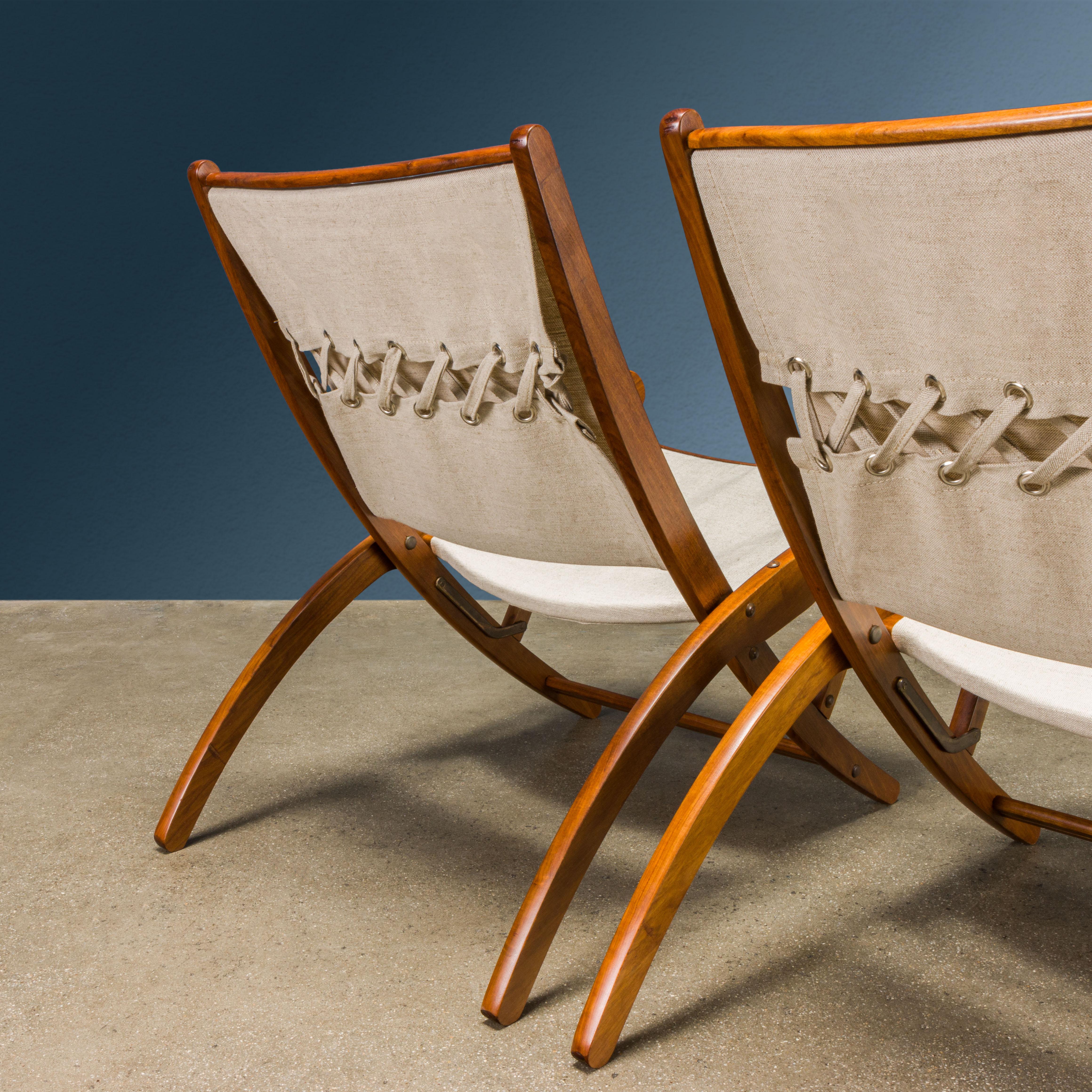 Pair of 'Ninfea' model folding armchairs with stained wood structure, backrest and seat in new linen fabric.
