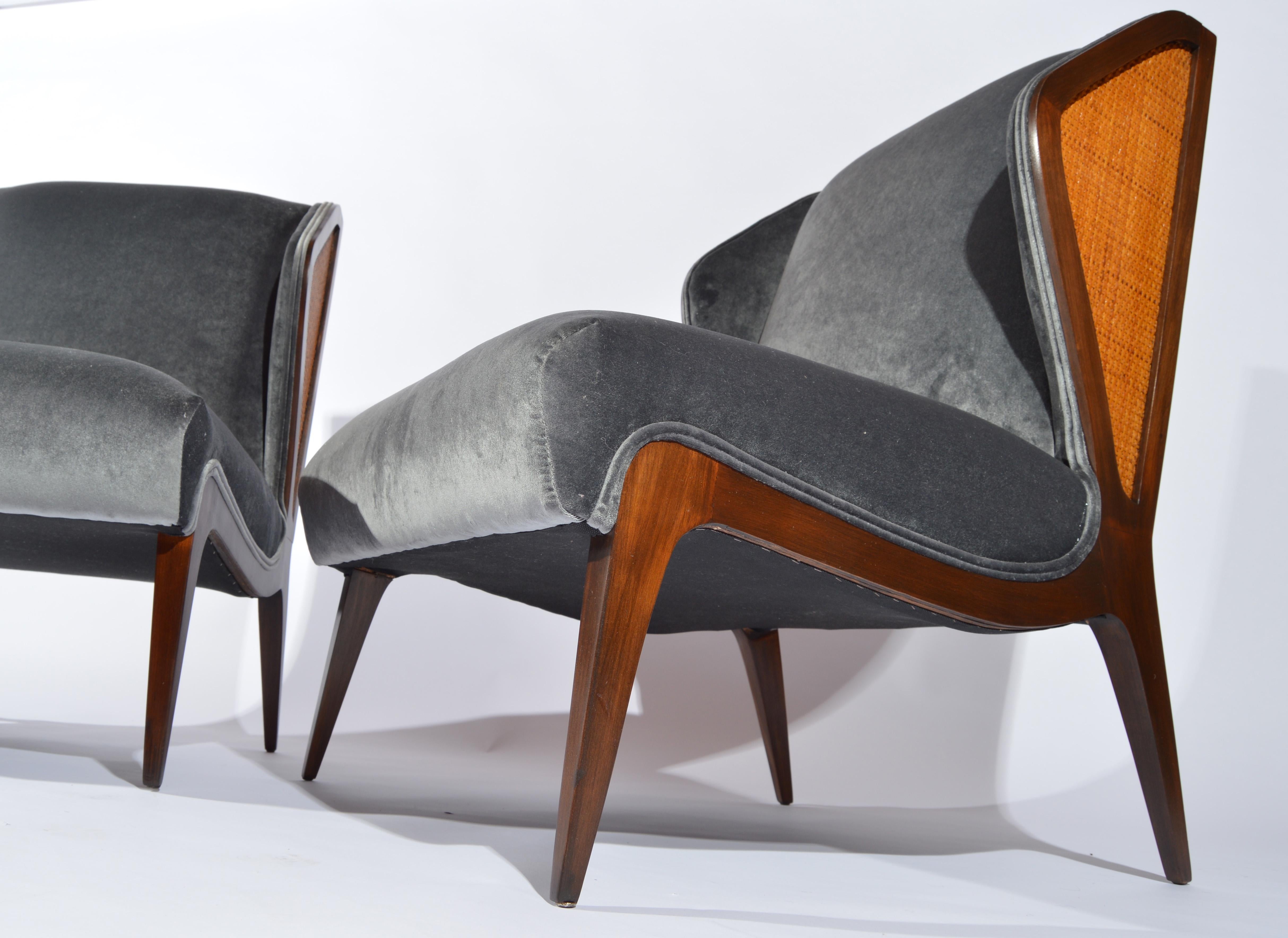 A pair of 1950s walnut cane embellished wingback slipper chairs in the manner of Gio Ponti having fresh gray velvet upholstery and cushioning.
   