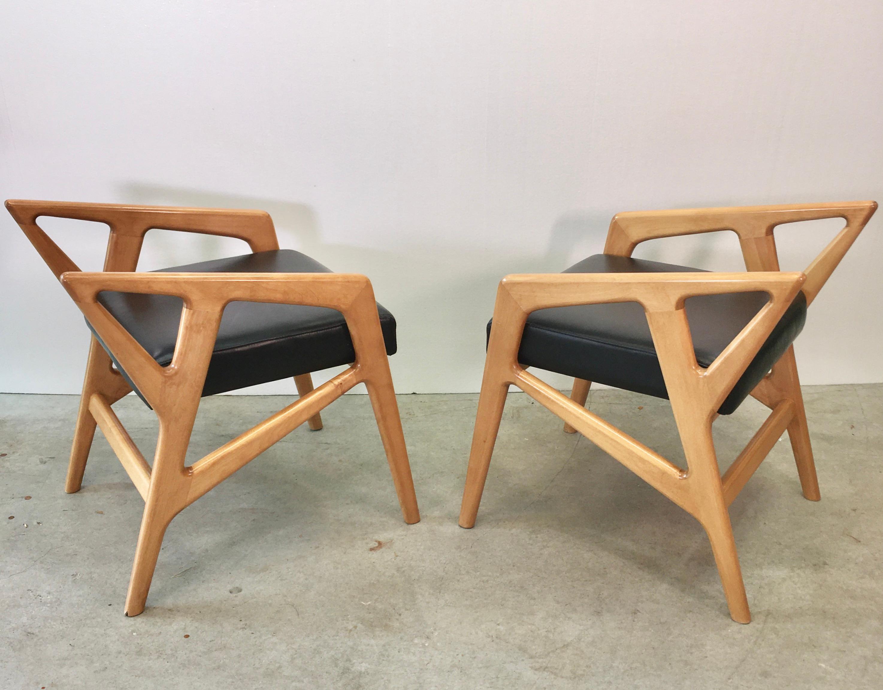 Pair of Gio Ponti style sculptural stools with newly upholstered black faux leather seats.
According to the Gio Ponti Archives the original design of these stools was Based Upon the model 687 chair for Cassina in 1953.
One can also observe the