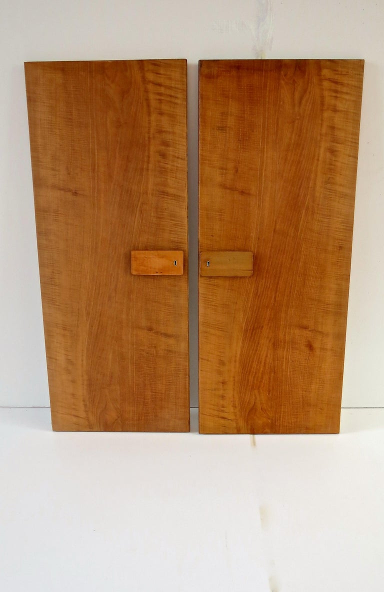 Rare pair of Gio Ponti wardrobe doors, 1955
from the furniture of the Hotel Royal, Naples
manufactured by Giordano Chiesa and produced by Dassi Lissone
mirrors on the verso
walnut, brass details and mirrors
original metal labels from Dassi on