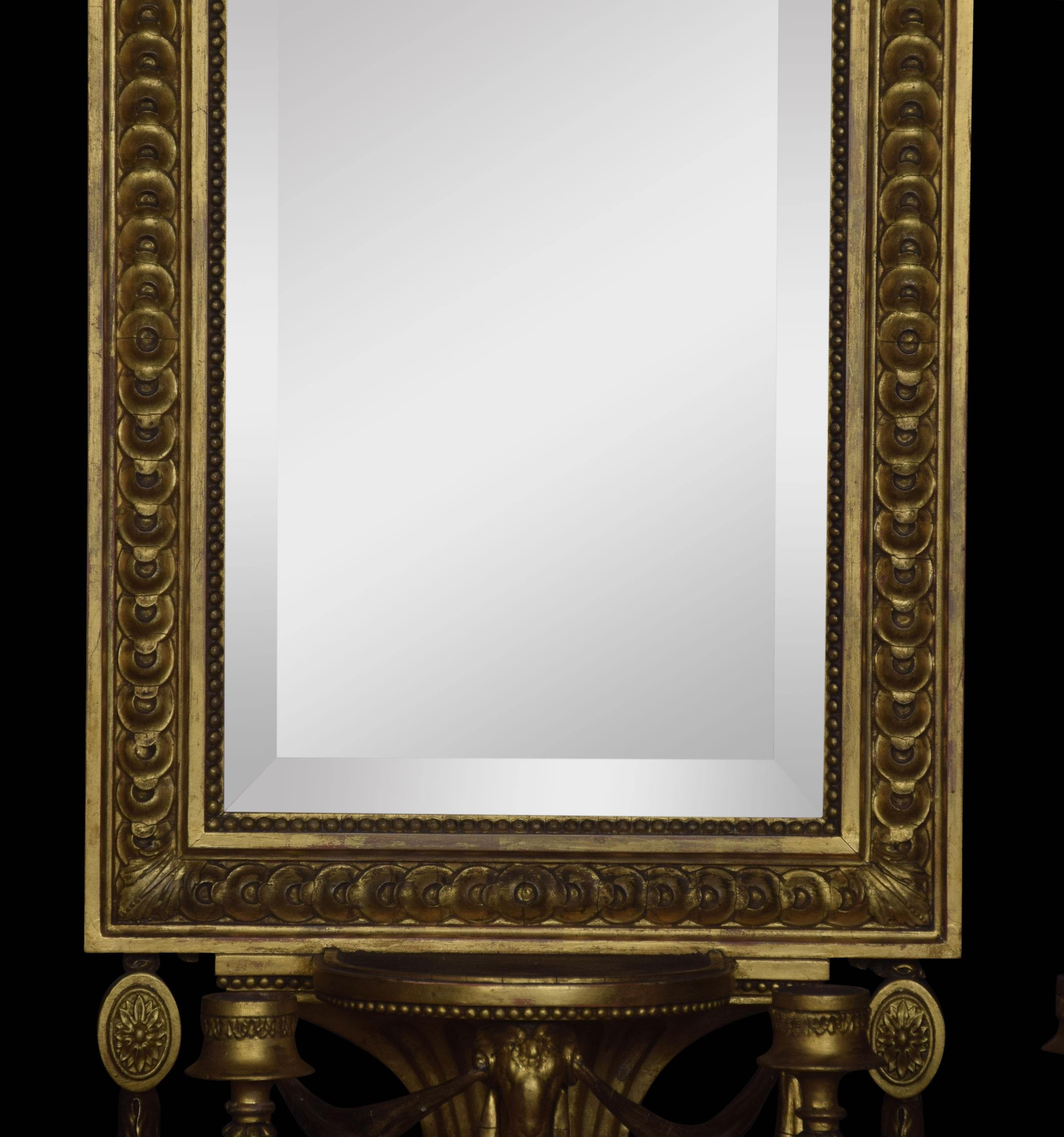 A pair of late 19th century girandoles. Each fitted with the original beveled plate and a small shelf below encased in a giltwood frame, with four scrolled sconces to the base.
Dimensions:
Height 27.5 inches
Width 13 inches
Depth 7 inches.