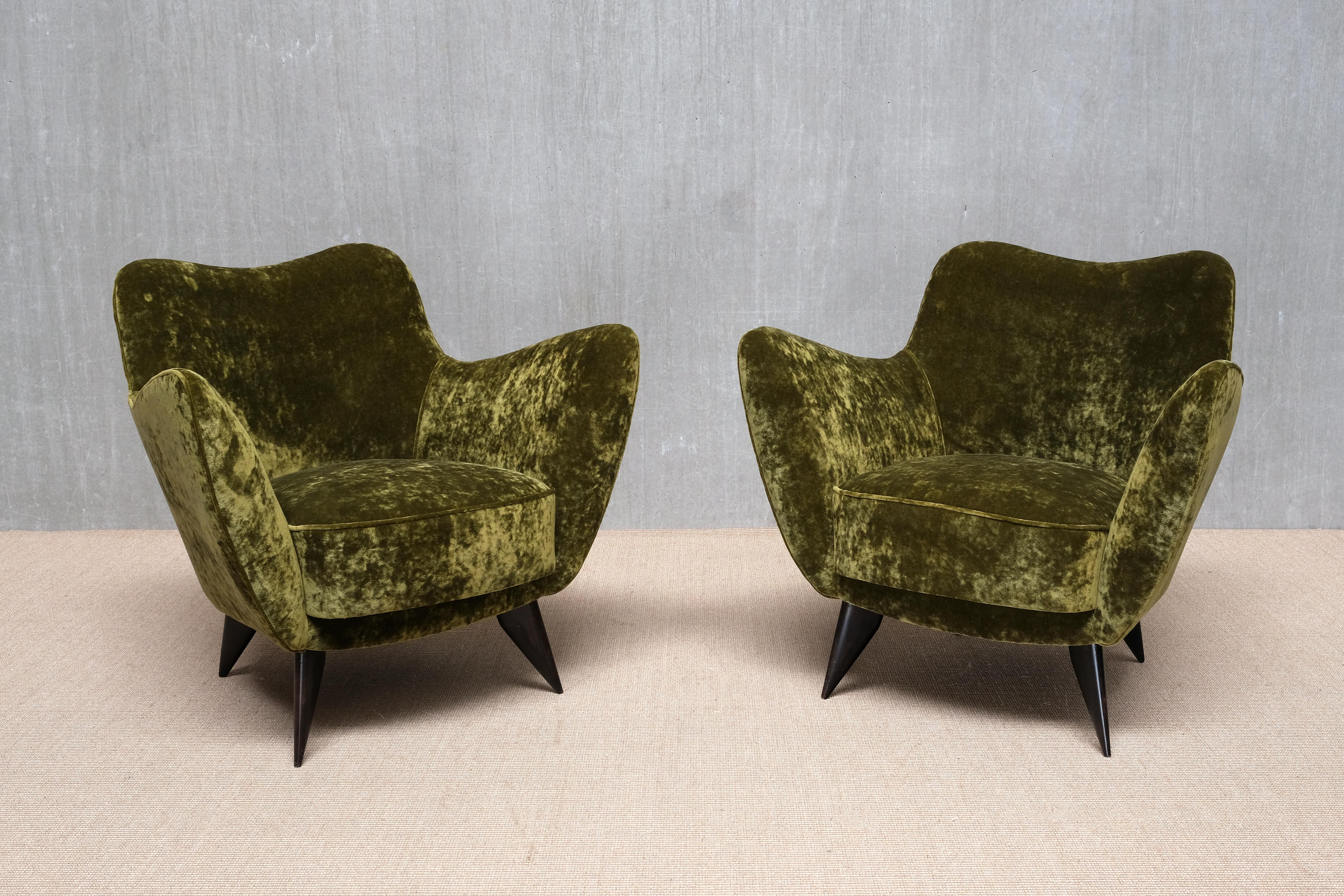 This rare pair of armchairs was designed by Giulia Veronesi and produced by ISA Bergamo, Italy, in the early 1950s. The model, known as Perla, is considered one of the iconic chair designs of the Italian Modern era. As shown in the fifth image, a
