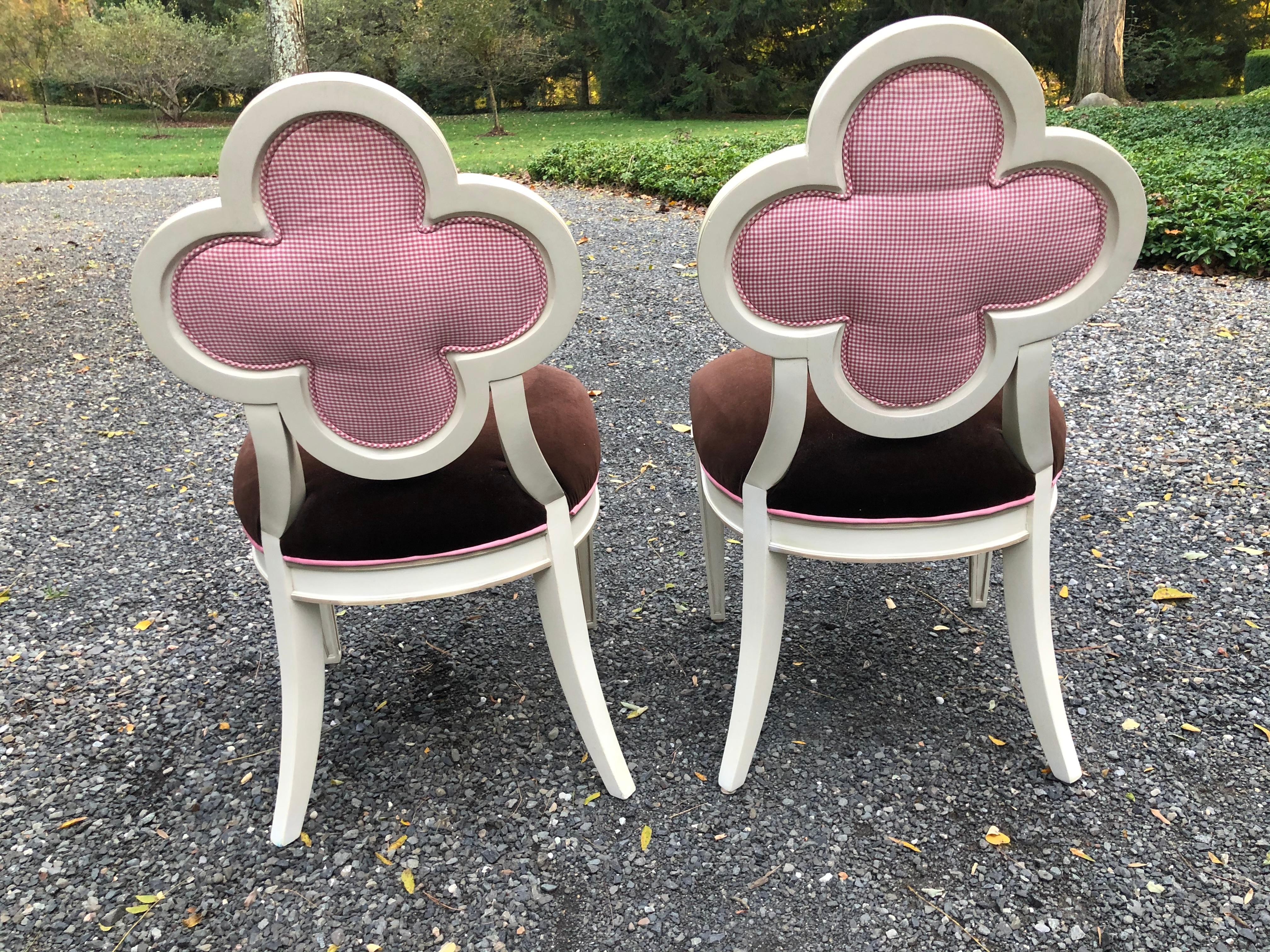 Pair of Alexandra accent chairs by designer Suzanne Kasler for Hickory Chair. The chairs have a quatrefoil back and tapering legs. They are upholstered in brown velvet accented with a pink silk check; the welting throughout is in a pink sateen. The