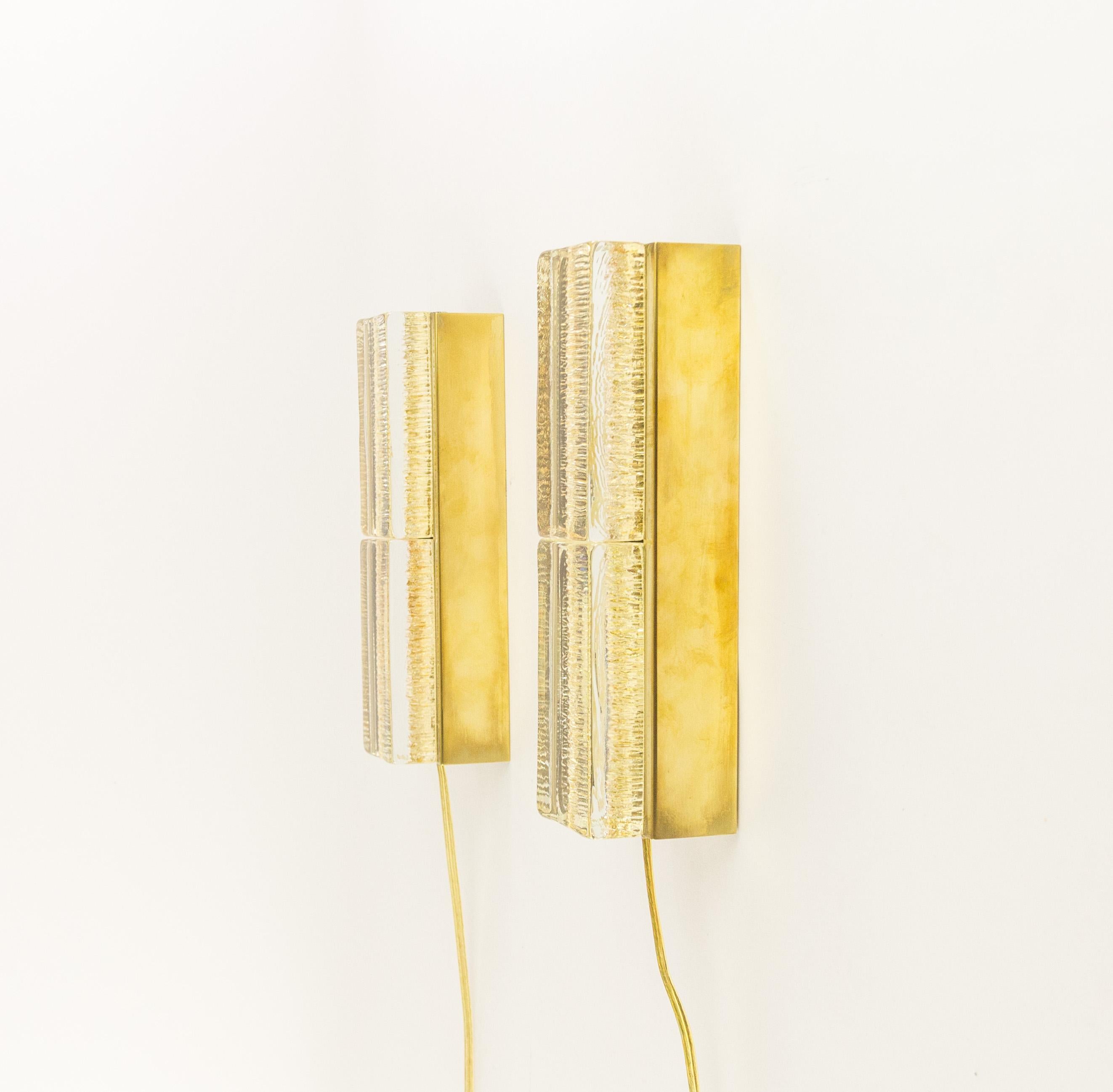A set of two double Atlantic wall lamps that are produced by Danish lighting manufacturer Vitrika in the 1970s. Both lamps consists of, two solid handmade glass bodies in gold, and the brass holder.

The condition of the brass parts is very good.