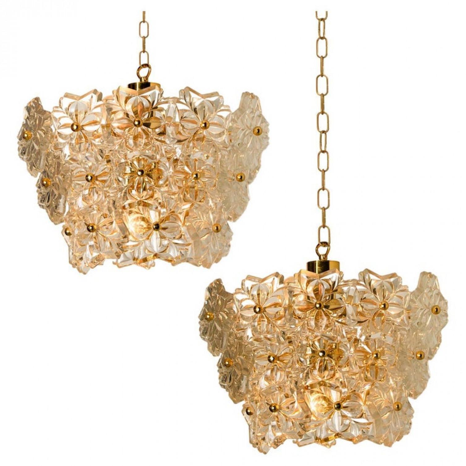 These sculptural chandeliers with a design of a bouquet of textured glass flowers and are from the historical lighting company Hillebrand,. Manufactured in midcentury, circa 1970 (late 1960s or early 1970s).

The fixture has several flower shaped
