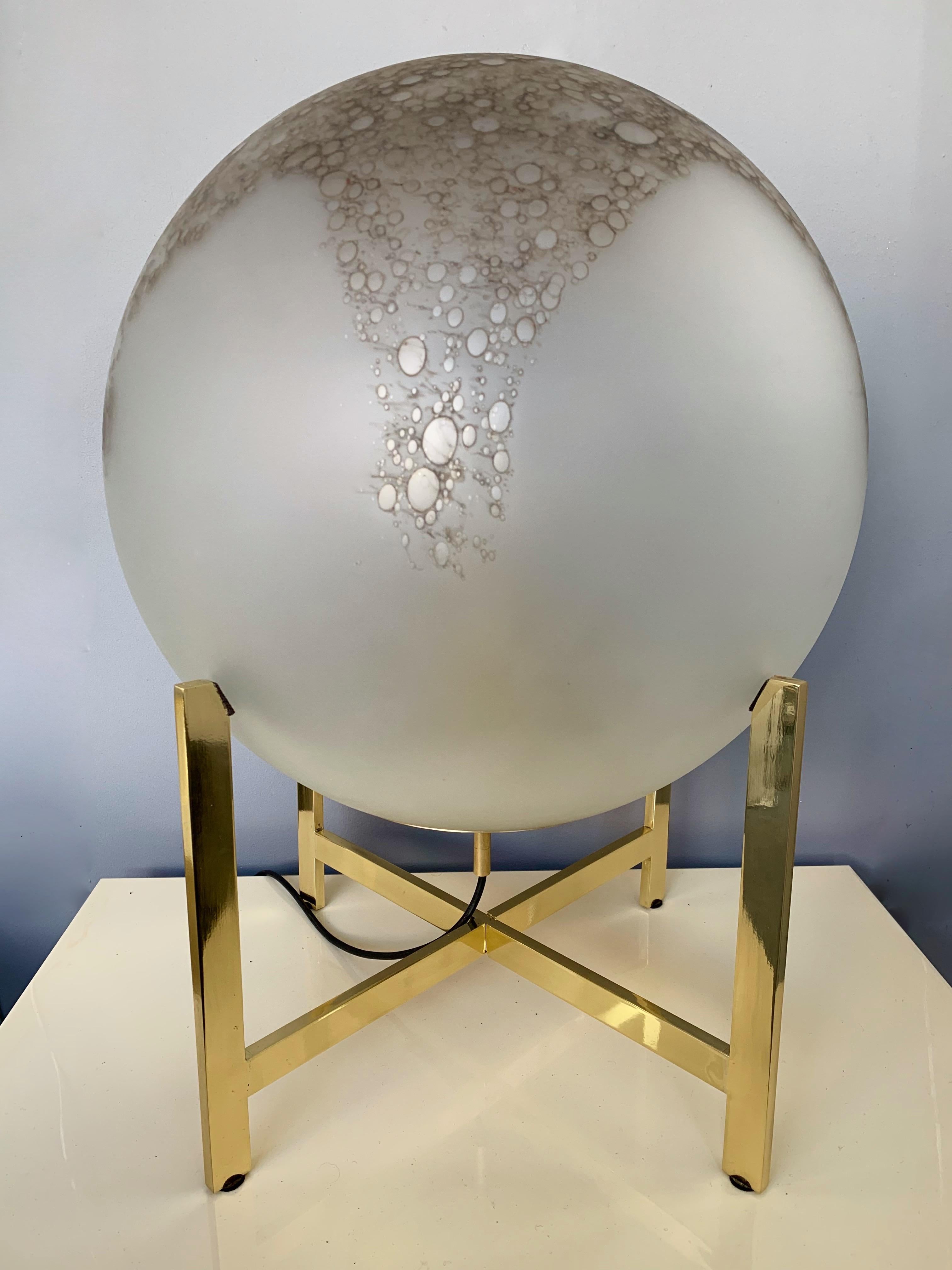 Impressive and very decorative floor or table lamps by La Murrina Murano. Sandblasted frosted blown glass sphere with iron oxid, which gives it this bronze color, the aspect seems like alabaster stone. Simple and elegant polish brass structure.