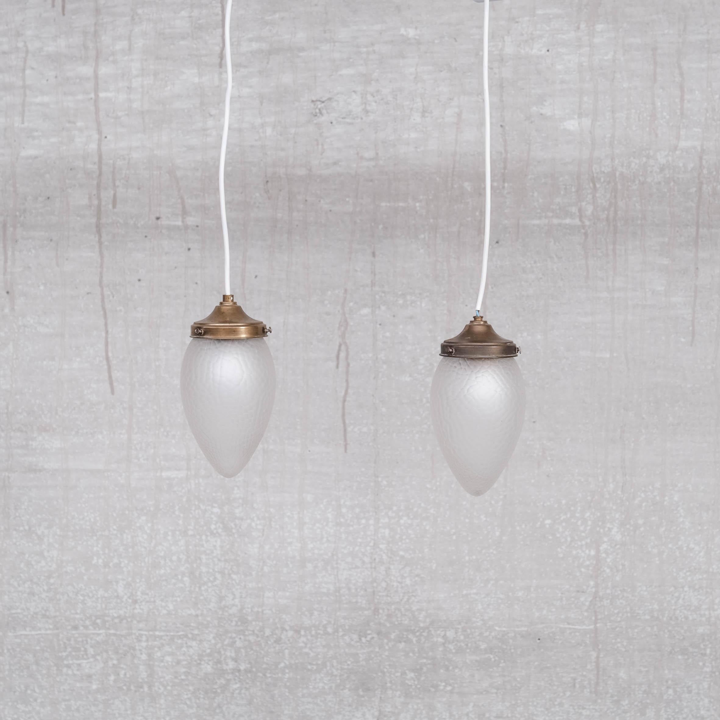 A pair of small glass pendants. 

Sweden, c1930s. 

Brass galleries, opaque glass. 

We could add a hook so they can be hung of a chain. 

Price is for the pair. 

Since re-wired and PAT tested. 

Location: Belgium Gallery.