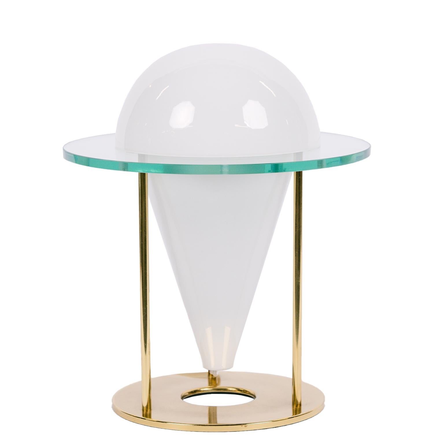 These unique conical shaped white glass lamps with a clear glass surround are inset in a lacquered brass holder. The top of the cone is removable so that you have access to the bulb. They date from the early 80's and are manufactured in Italy by