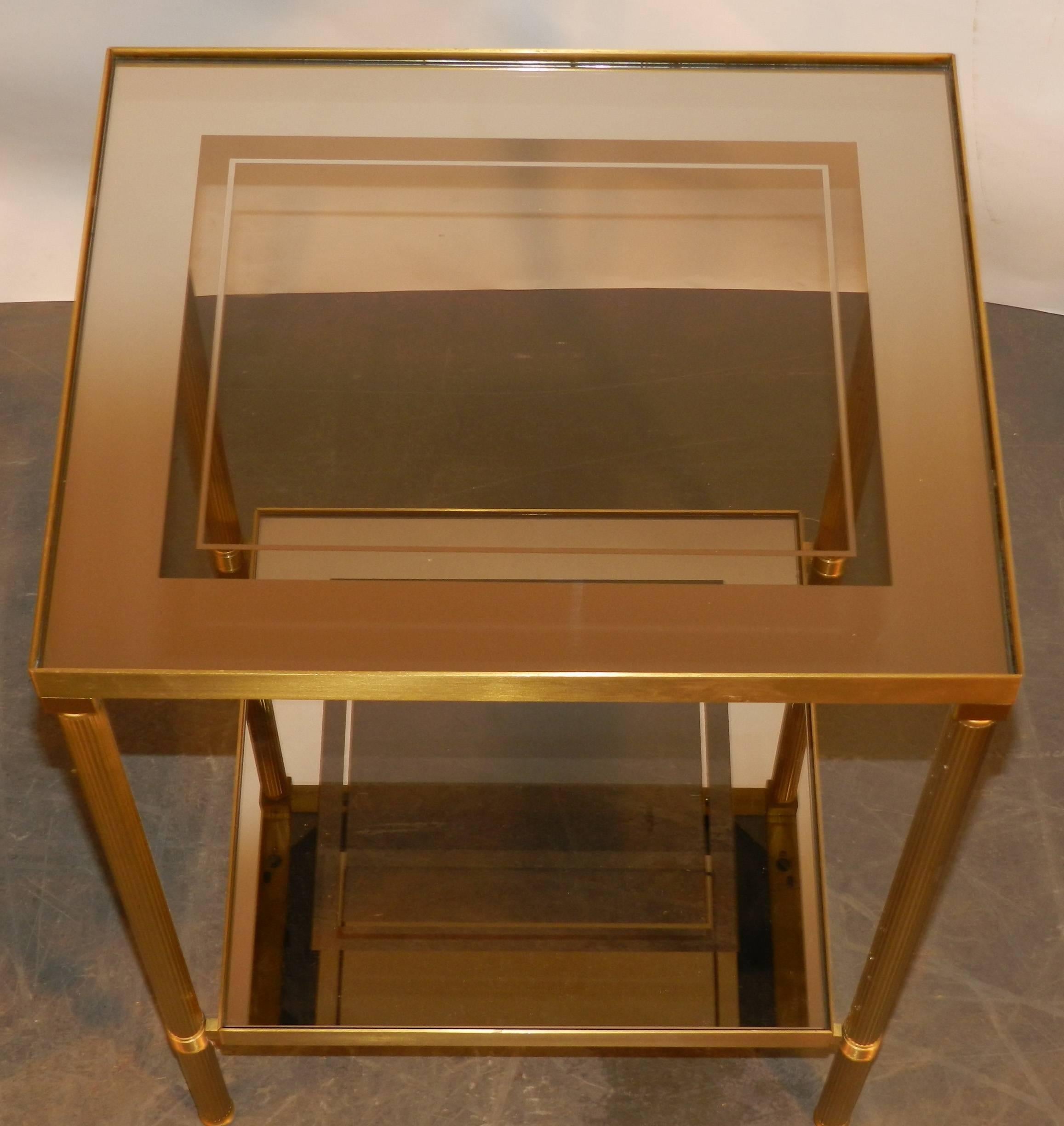 Pair of glass and mirror and brass side tables.