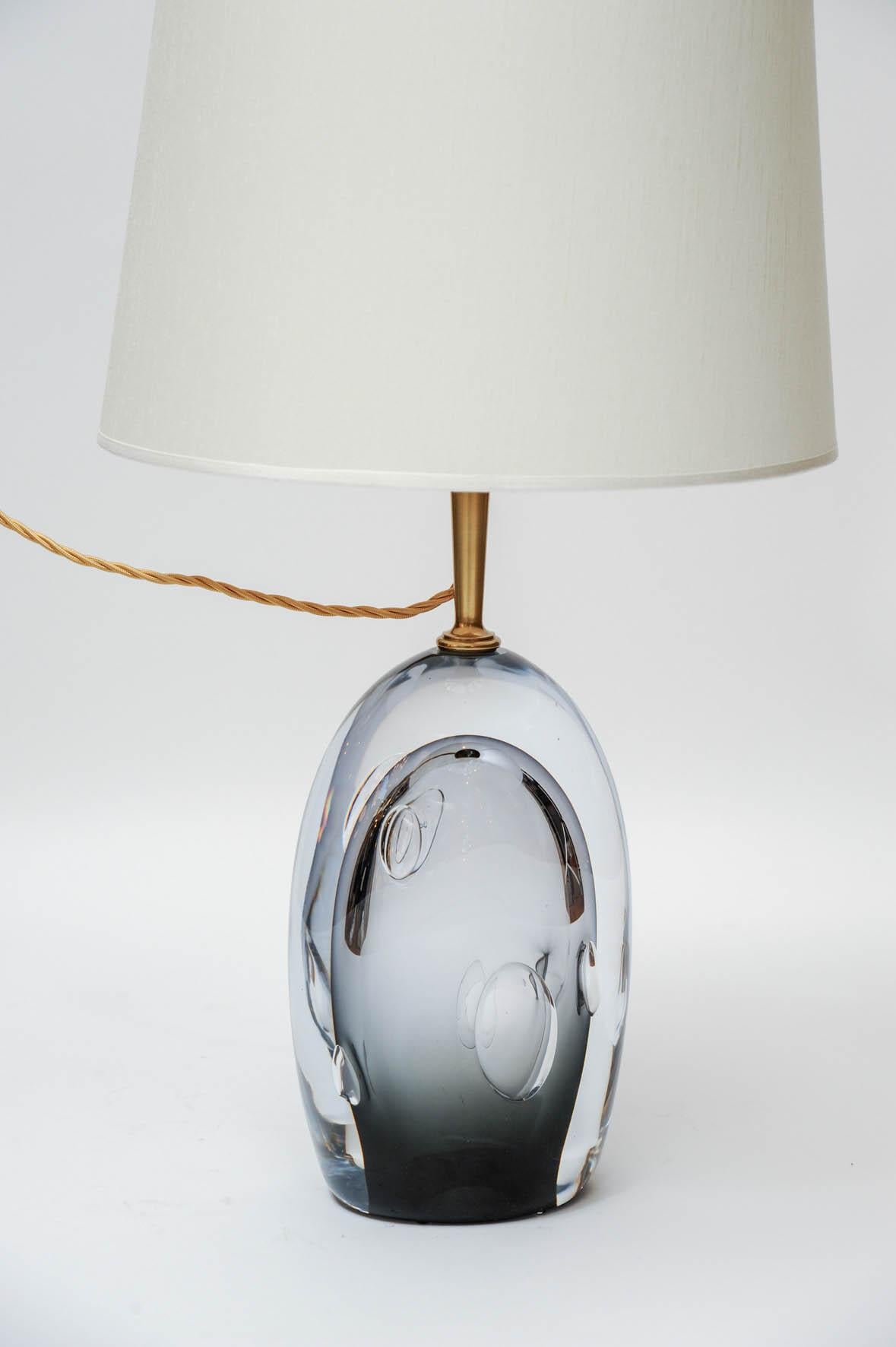 Pair of table lamps made by Italian edition house Esperia for Glustin Luminaires.

Big glass piece lightly tinted in black giving the lamp almost a purple colour and air bubble trapped inside, topped with a brass neck.