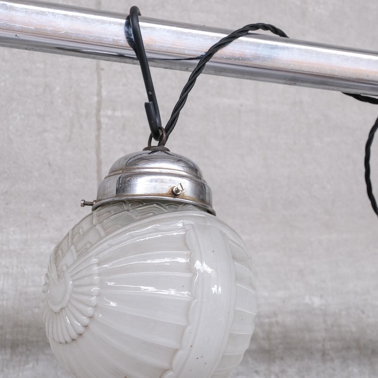 A pair of deco diminutive pendant lights.

France, c1930s.

Metal and opaque glass.

Price is for the pair.

No chain or rose available but these are sourced easily online.

Location: Belgium Gallery.

Dimensions: 20 H x 15 Diameter in