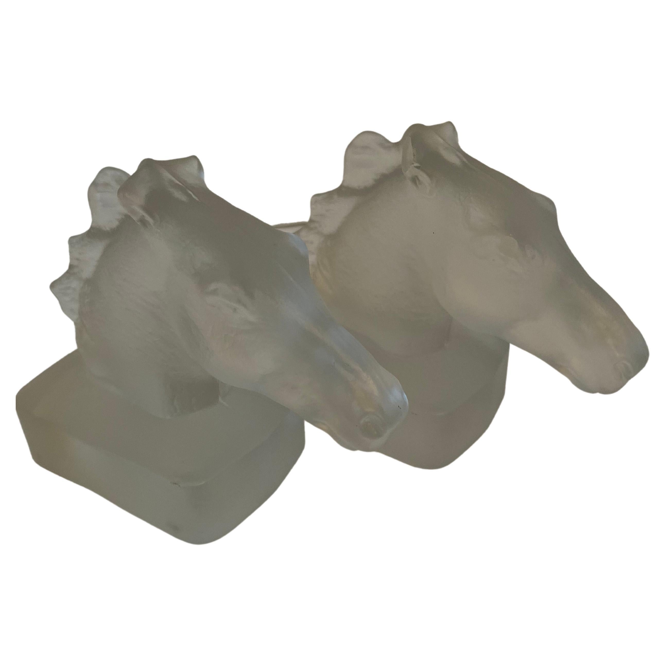 A wonderful pair of frosted Horse Head sculpture bookends. The pair could be used as decorative pieces but also are perfect for bookends, especially in a Childs room. They are molded glass but definitely have a look of Lalique.