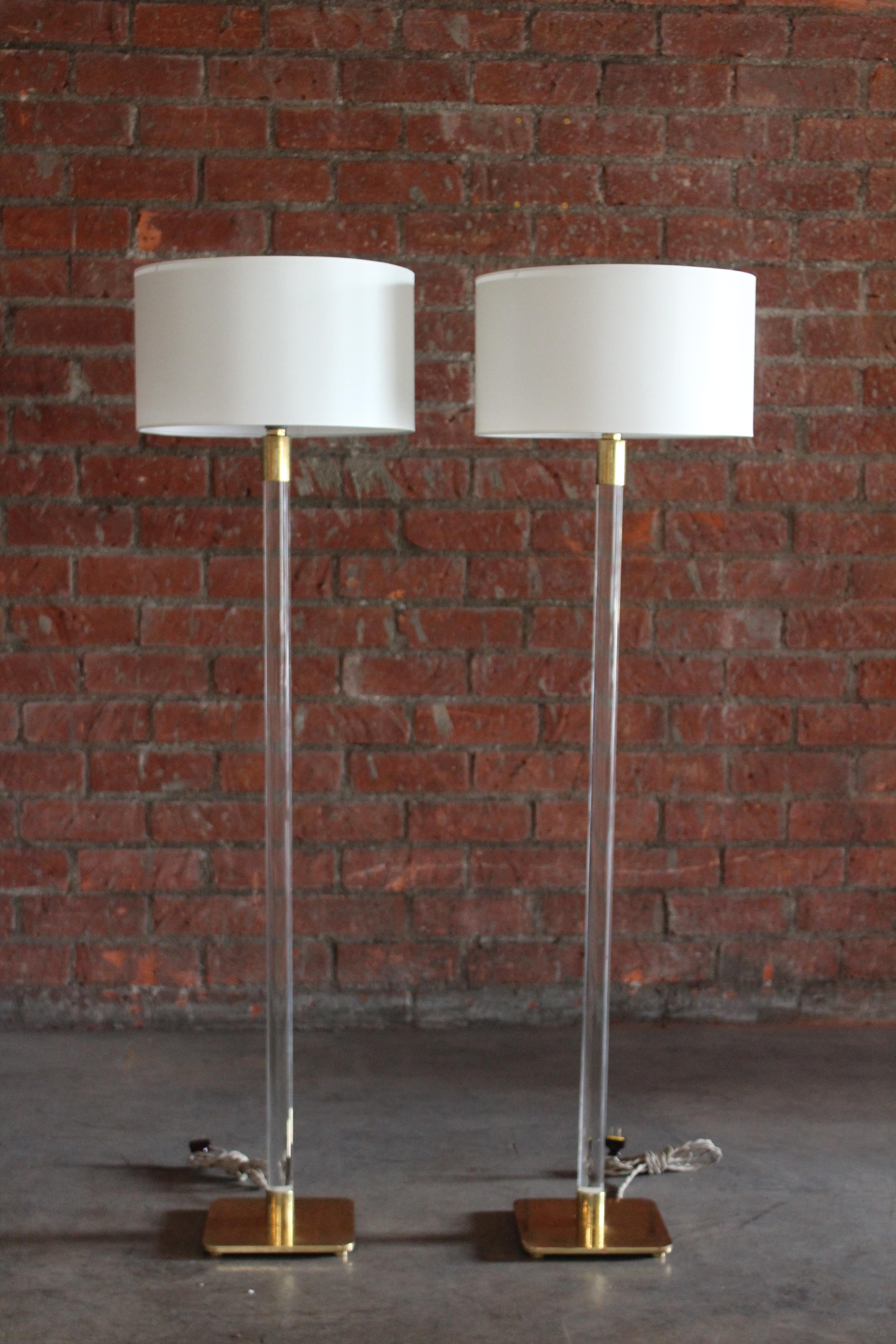 Pair of glass floor lamps on brass bases by Hansen NYC, from the 1970s. New custom made shades in silk. Rewired in brown twisted silk cords. In over all excellent condition. Brass shows patina. 57