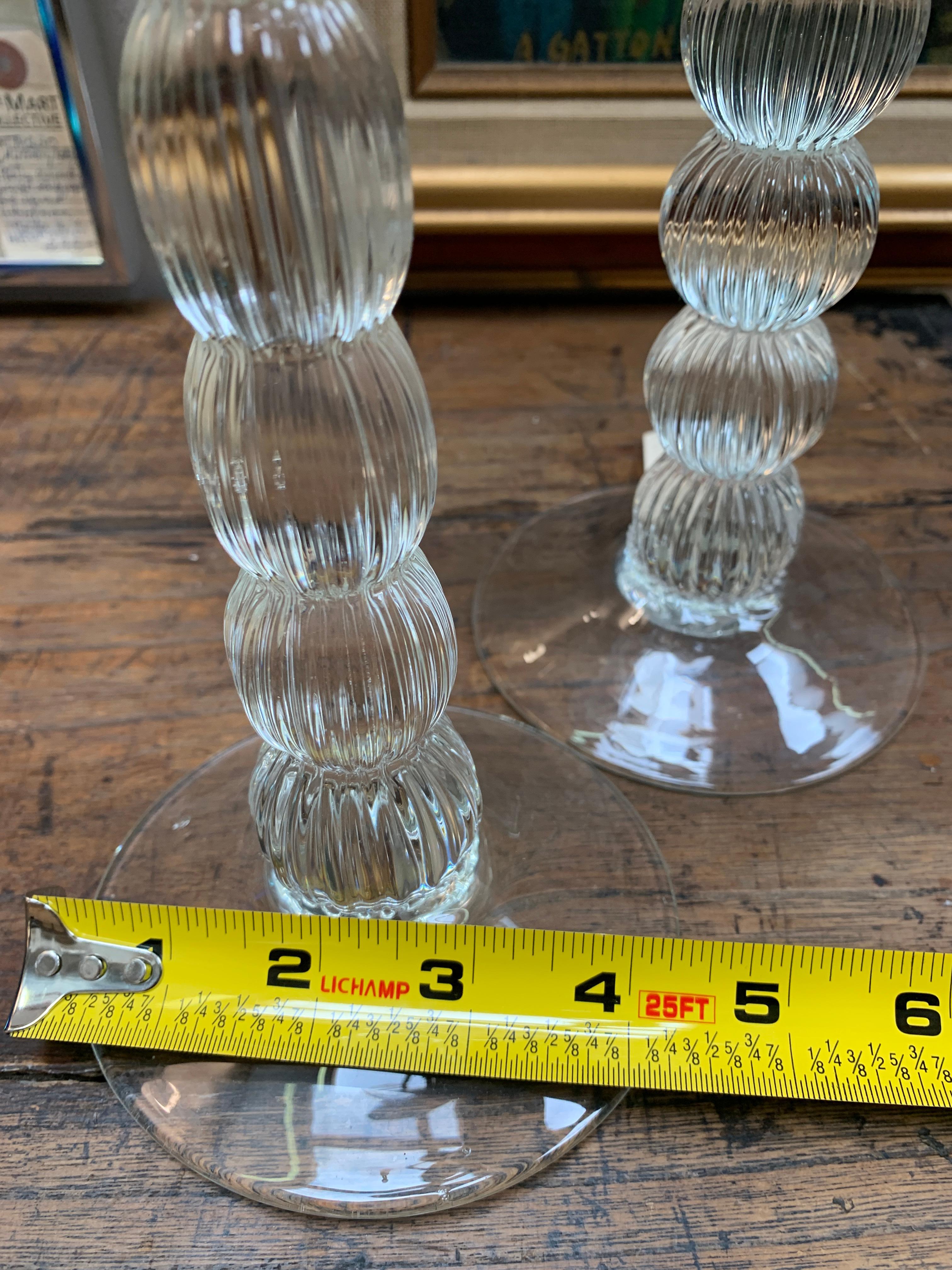 A wonderful pair of ridged glass candle sticks, perfectly simple for any table or dining room.