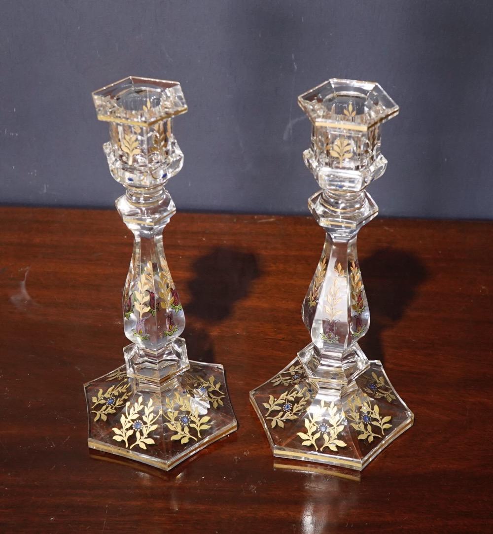 Pair of glass candle sticks with gold etching and enamel decoration of flowers and leaf detail, the bases engraved with numbers, circa 1900.

                               