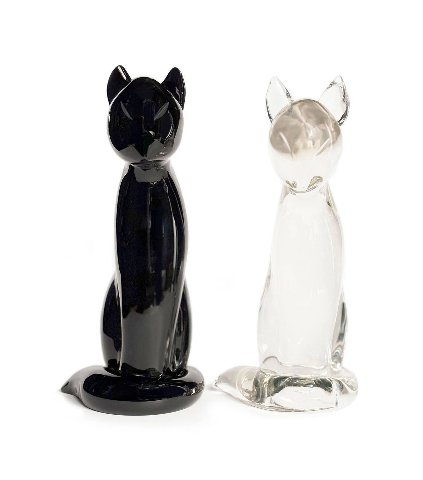Pair of glass sculptures Cats
Archimede Seguso (attr.)
Seguso Vetri d’arte 
Murano, circa 1960-1970 
Dimensions: 
achrome cat: height 9.45 in x 4.49 in x 5.24 (24 cm x 11.4 x 13.3); 
weight: 4 lb (2.05 kg)
black cat: height 9.65 in x 5.53 x 4.72