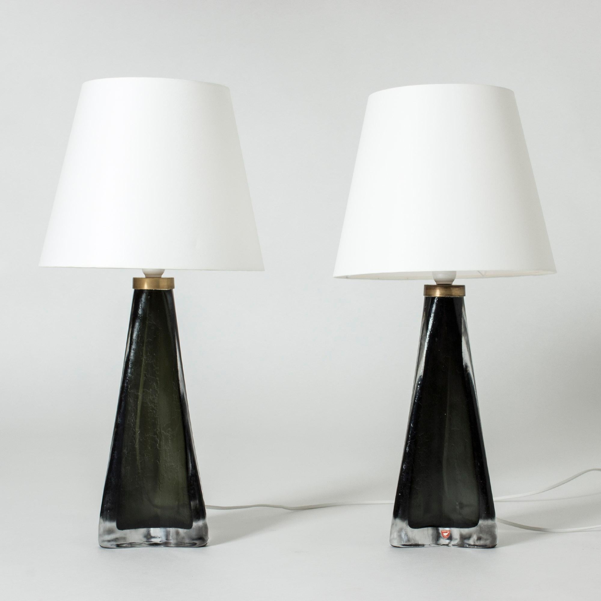 Pair of cool and luxurious table lamps by Carl Fagerlund, made in nearly opaque black and clear glass. Tapering shape with a triangular base. Slightly frosted surface with structure.