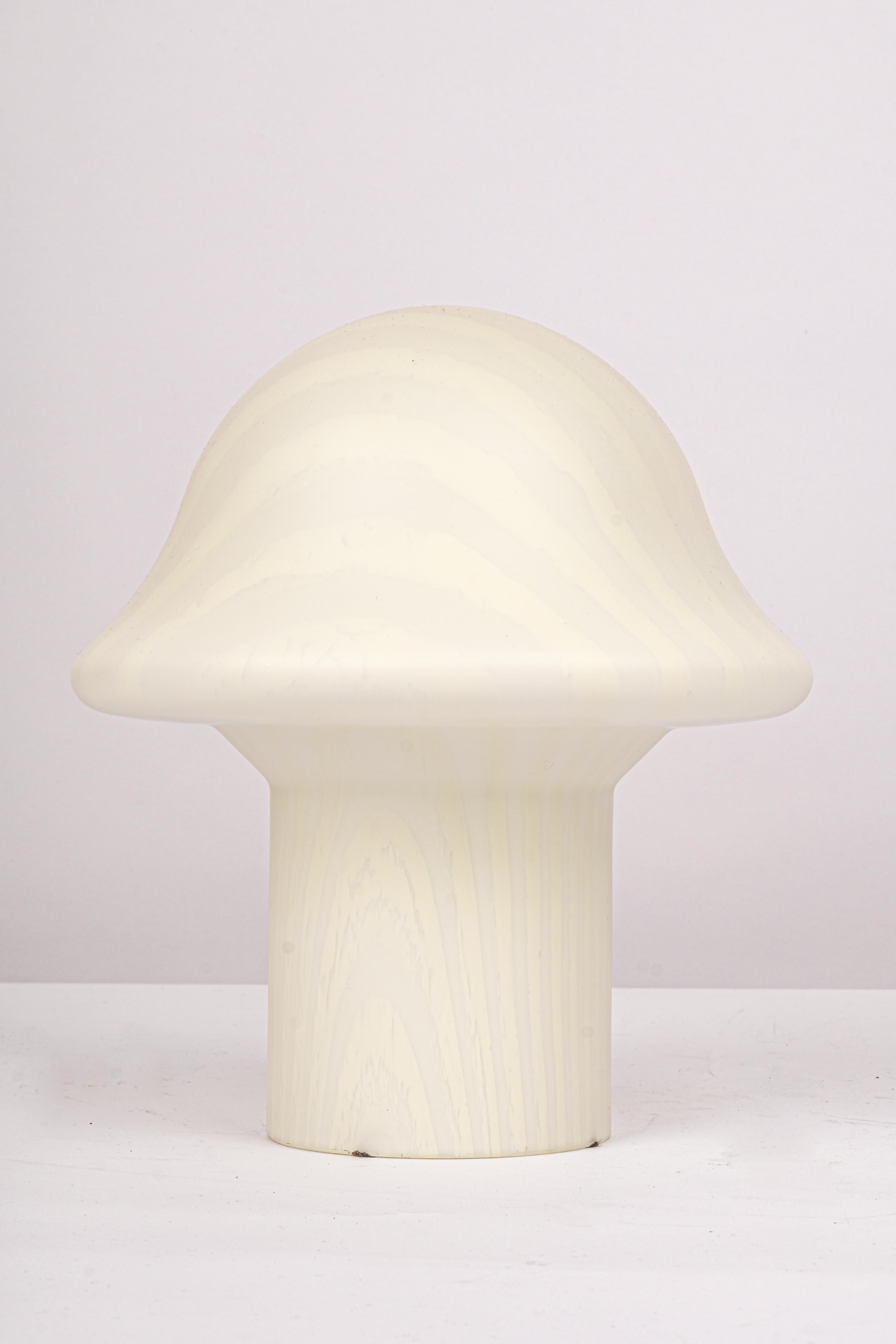 Wonderful pair of midcentury mushroom table lamps by Peill & Putzler, Germany, 1970s.
Made of a single piece of blown and cased glass.
Manufacturer: Peill & Putzler

Stunning glass form and in very good condition. Cleaned, well-wired, and ready
