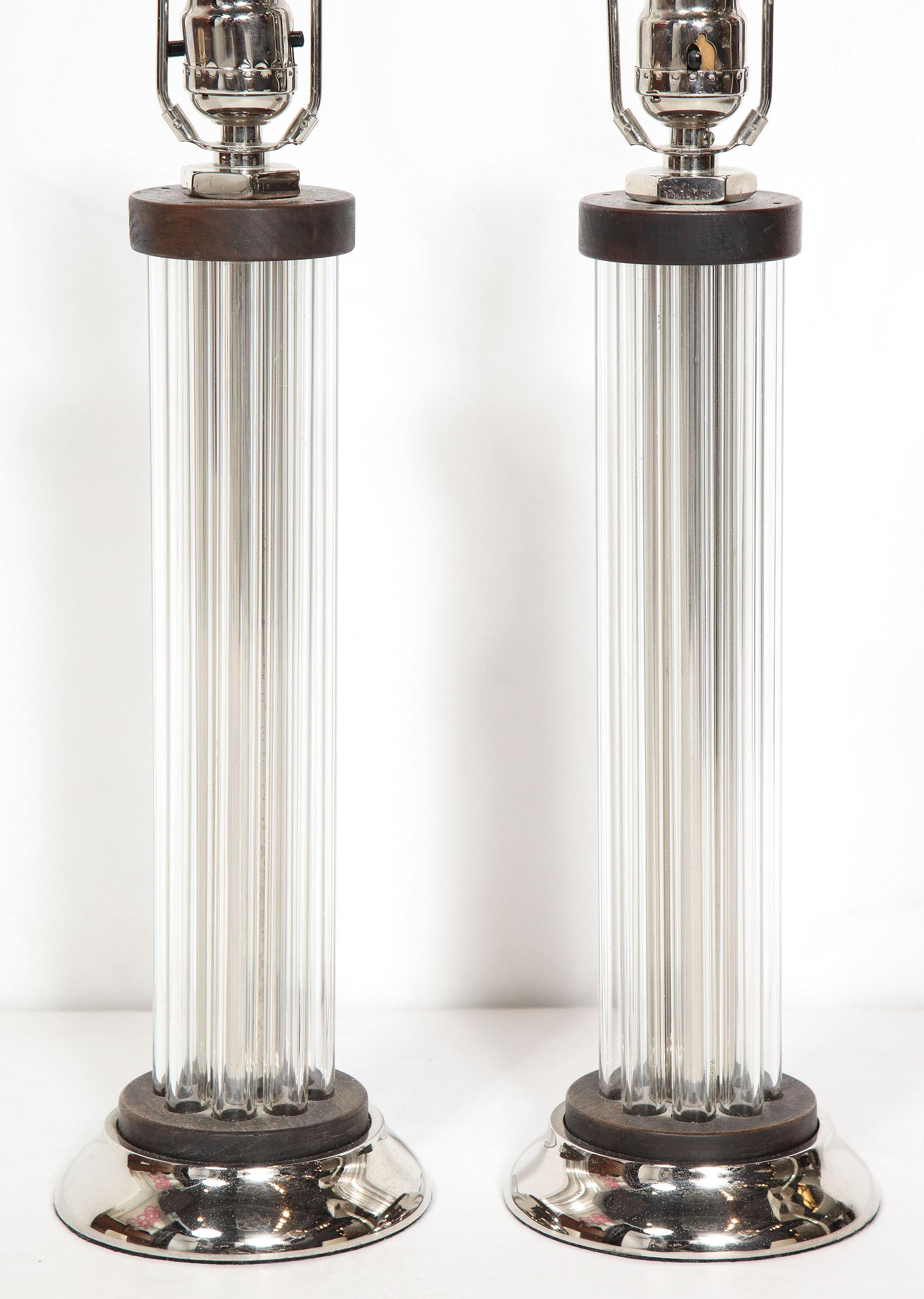 Pair of Art Deco glass column lamps

The Art Deco lamps constructed of glass tubes assembled as a central column on a metal base.