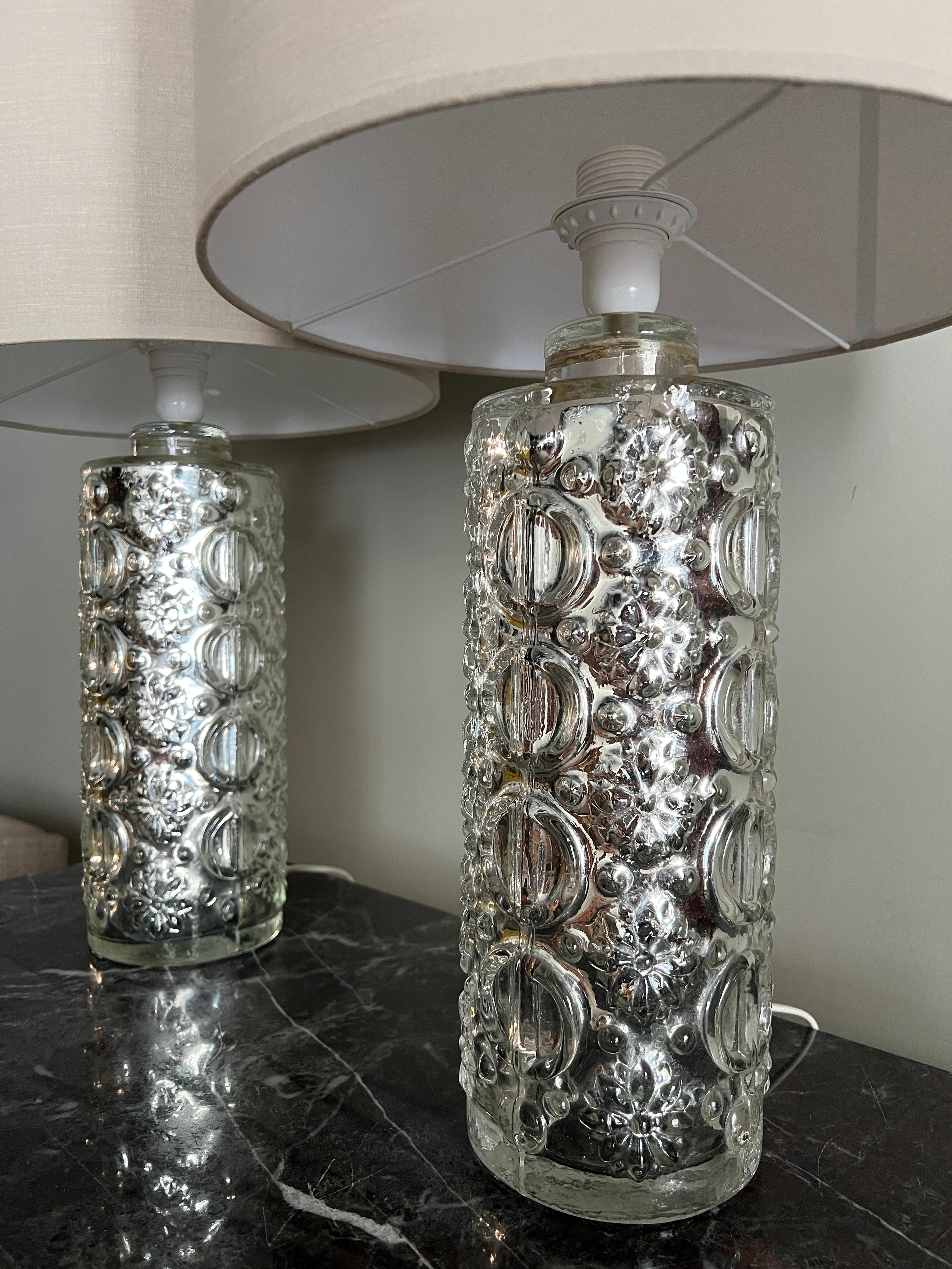 A pair of glass tables lamps by gustav leek for Orrefors Sweden circa 1960

Size of the base H 35 cm excluding socket 
Total Height with shade : 71 cm.