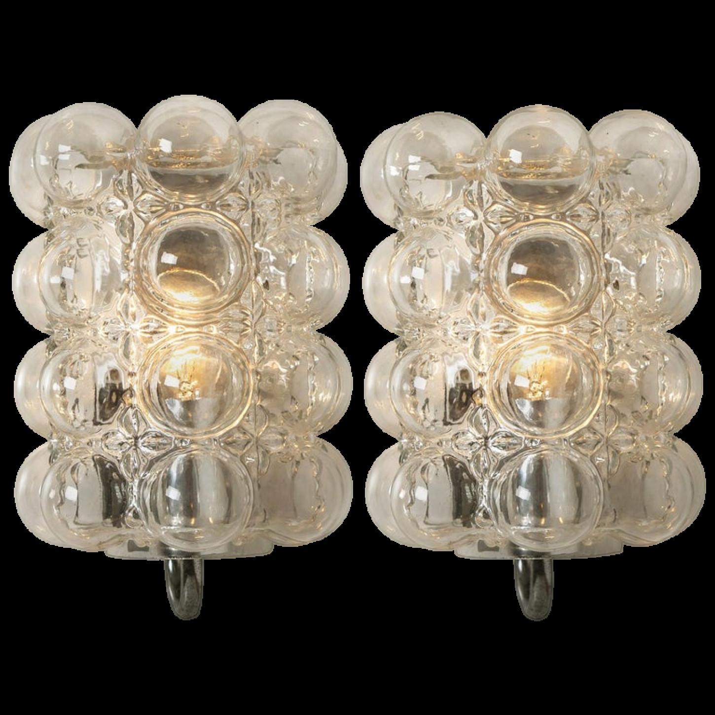 A pair of beautiful bubble glass wall lights designed by Helena Tynell for Glashütte Limburg. A design Classic, the clear colored or toned of the hand blown glass gives a wonderful and warm glow.xa0

Helena Tynell is a Finnish glass and ceramics