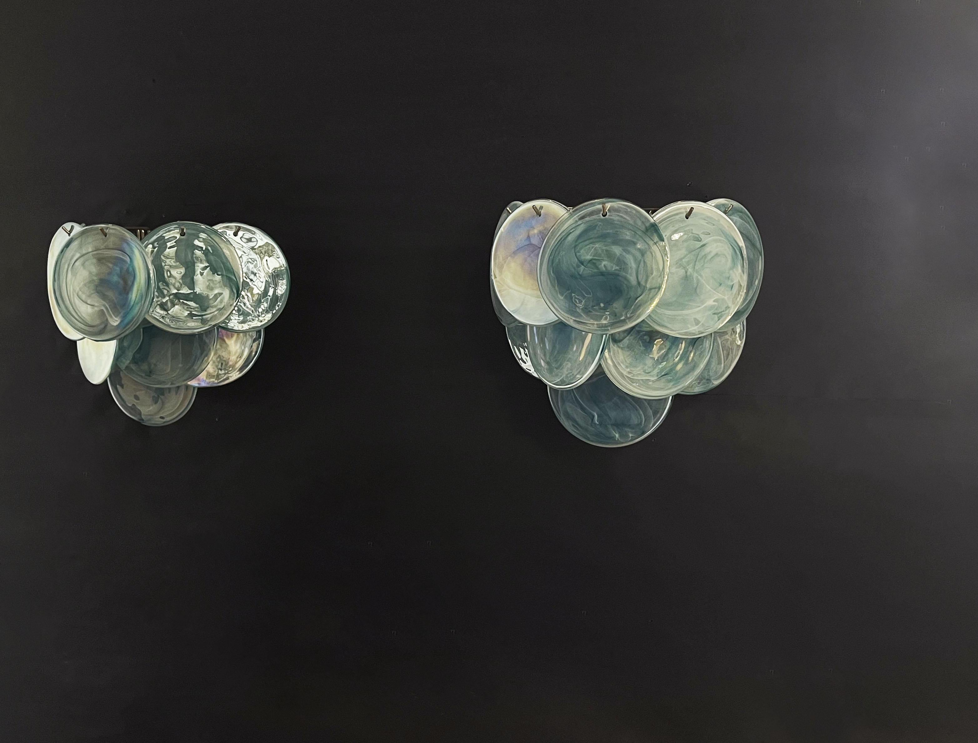 Pair of vintage Italian Murano appliques in Vistosi style. Wall lights have 10 glass for each, iridescent alabaster blue discs. The glasses are now unavailable, they have the particularity of reflecting a multiplicity of colors, which makes the