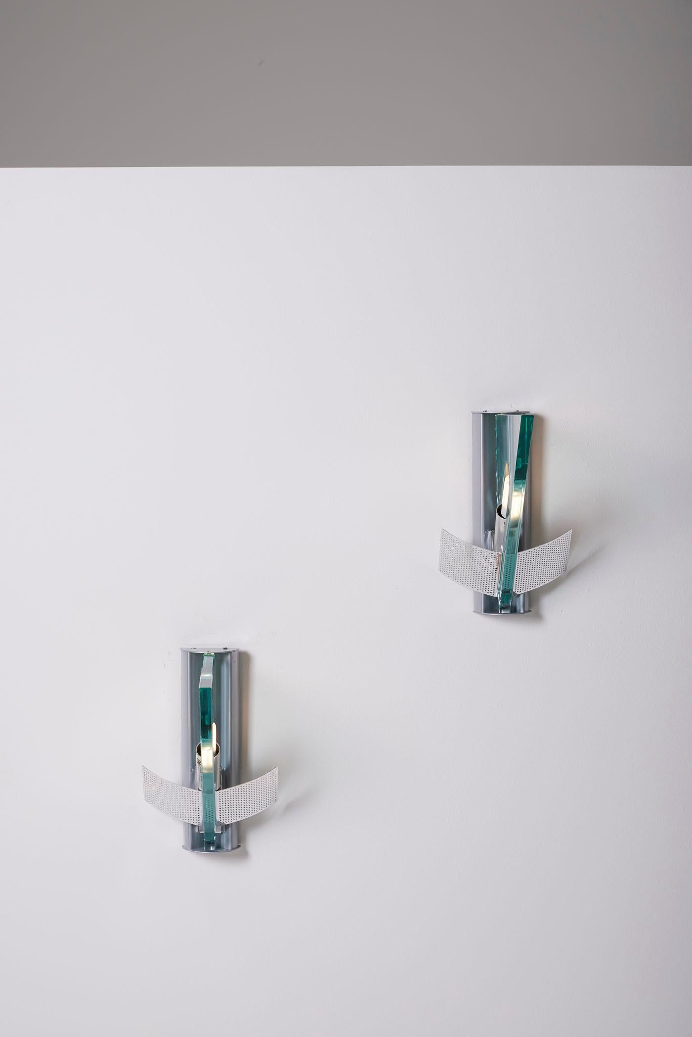 Pair of wall sconces, Icaro model, designed by Carlo Forcolini for Artemide in the 1980s. These sconces are made of metal and glass, with a perforated metal reflector. Very good condition.
LP1973
