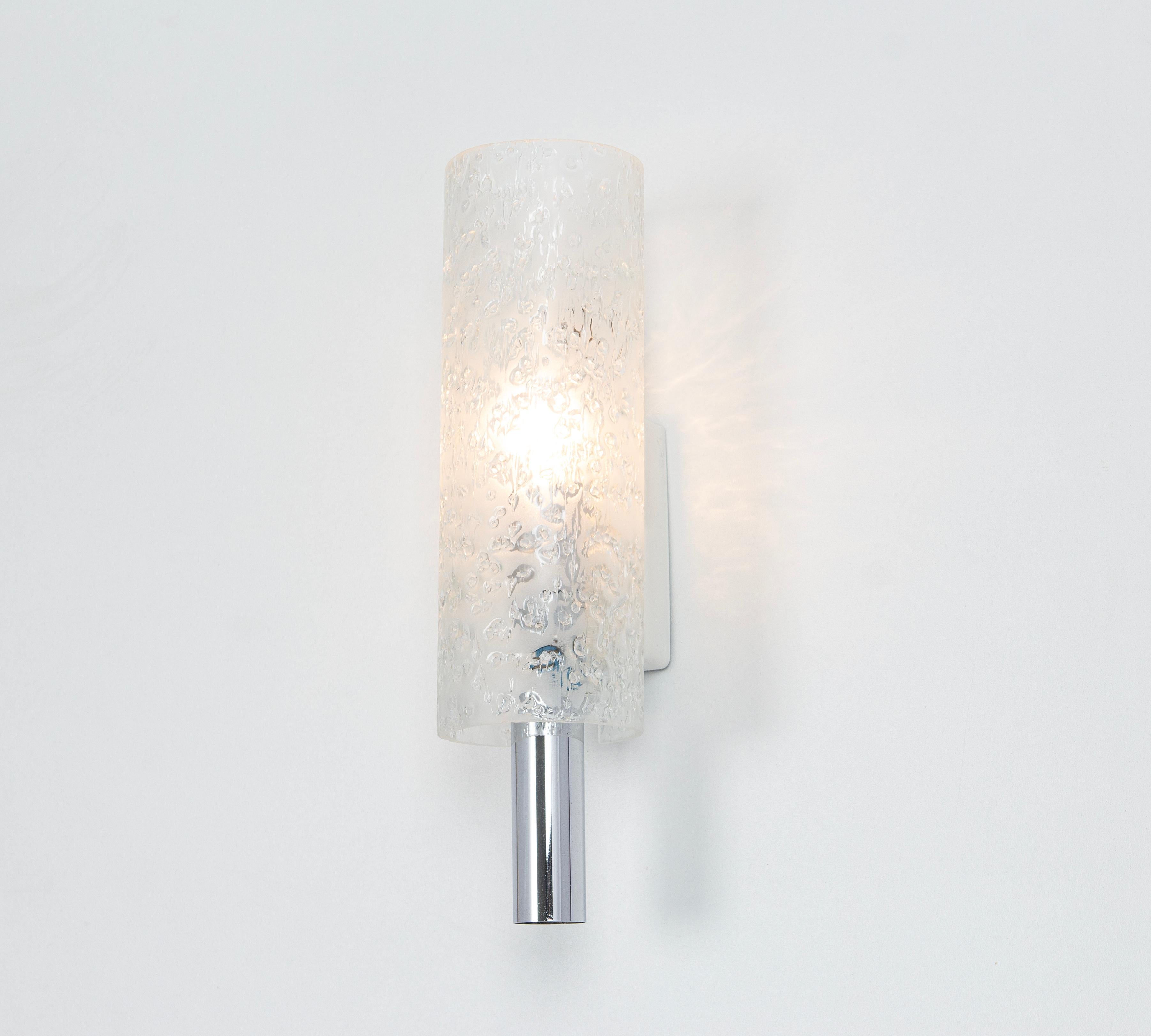 Wonderful pair of mid-century wall sconces with ice glass tubes, made by Doria Leuchten, Germany, manufactured, circa 1960-1969.
High quality and in very good condition. Cleaned, well-wired, and ready to use. 

Each sconce requires 1 x E14 small