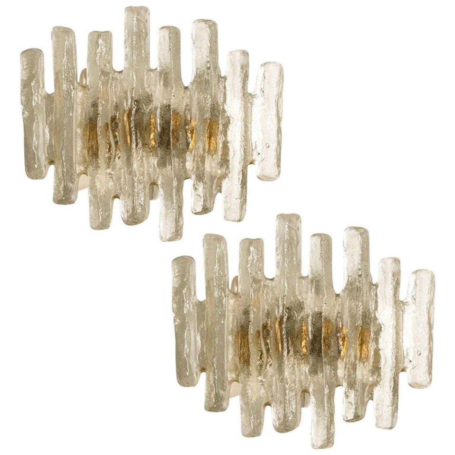 Pair of beautiful and elegant modern wall lights or sconces, manufactured by J.T. Kalmar Austria in the 1970s. Lovely design, executed to a very high standard.

Each wall light has 1 large solid ice glass sheets dangling on it. With a white back