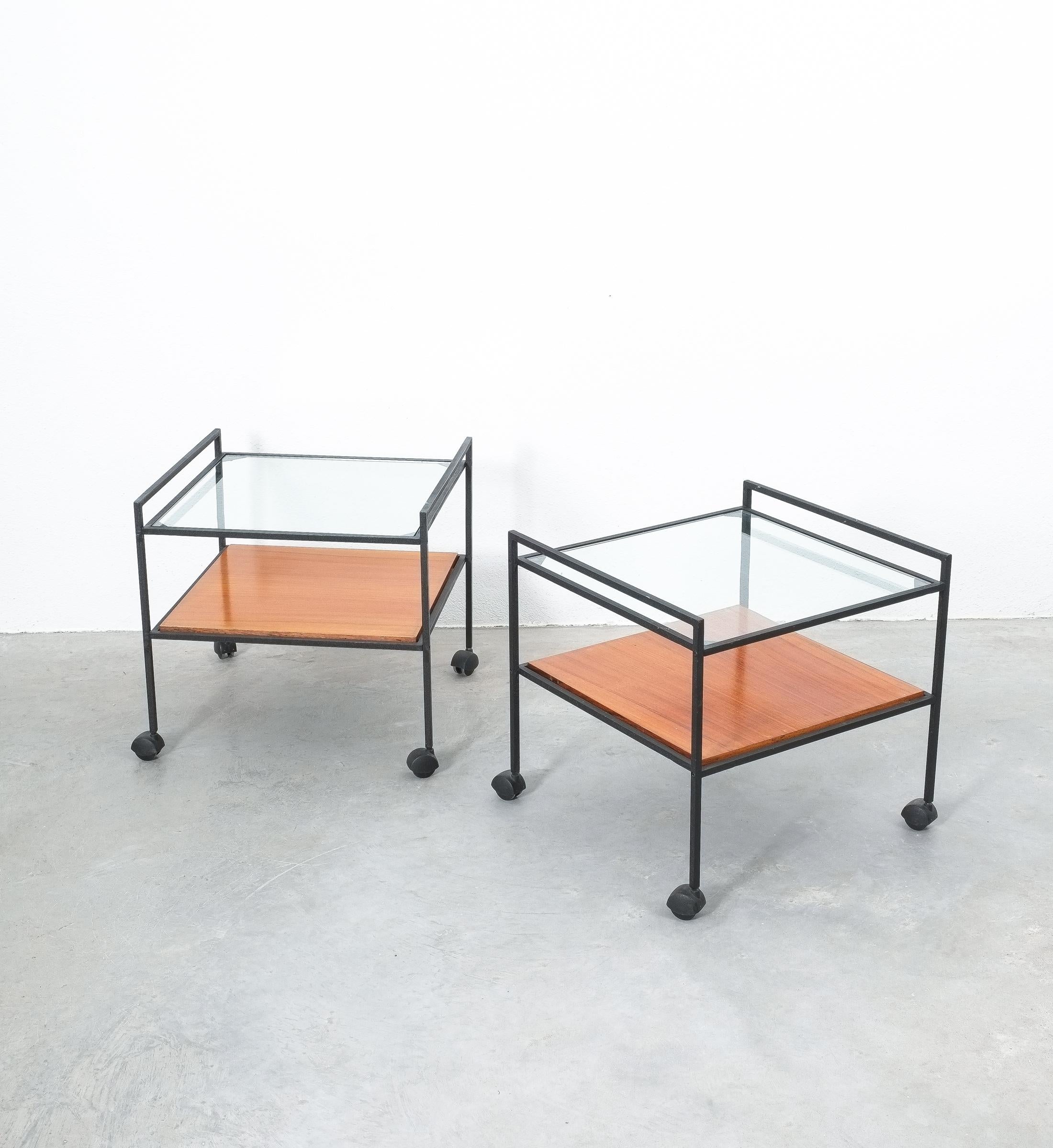 Pair of glass wood iron tables, Italy, 1960

Nice pair of glass and wood coffee tables, priced as a pair. Identical tables both on casters. They can be used as side tables also due to the size (approximate 20 x 20 x 20
