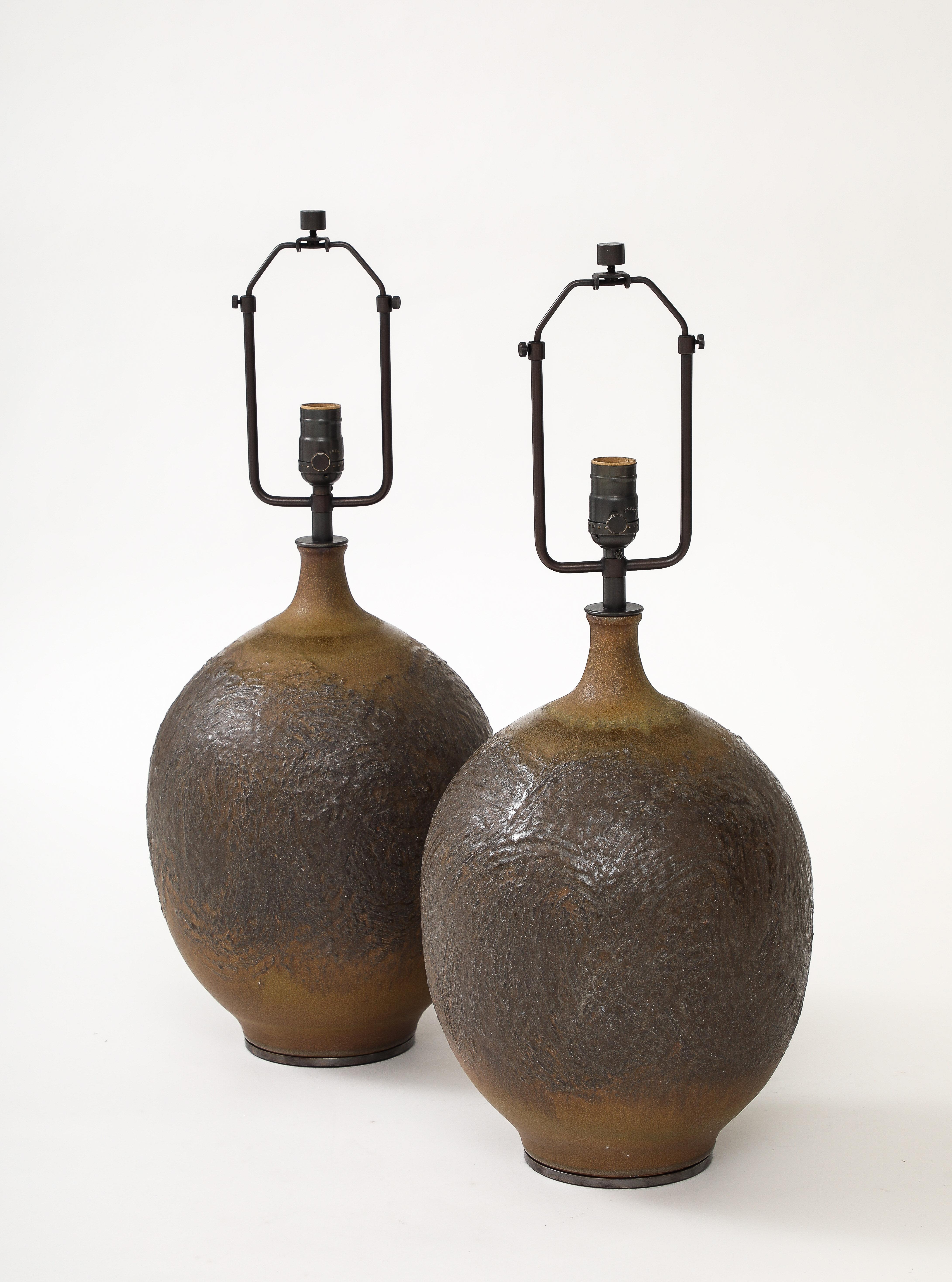 These glazed ceramic table lamps have a beautiful tone and texture; it almost appears that they're made of cast bronze.
